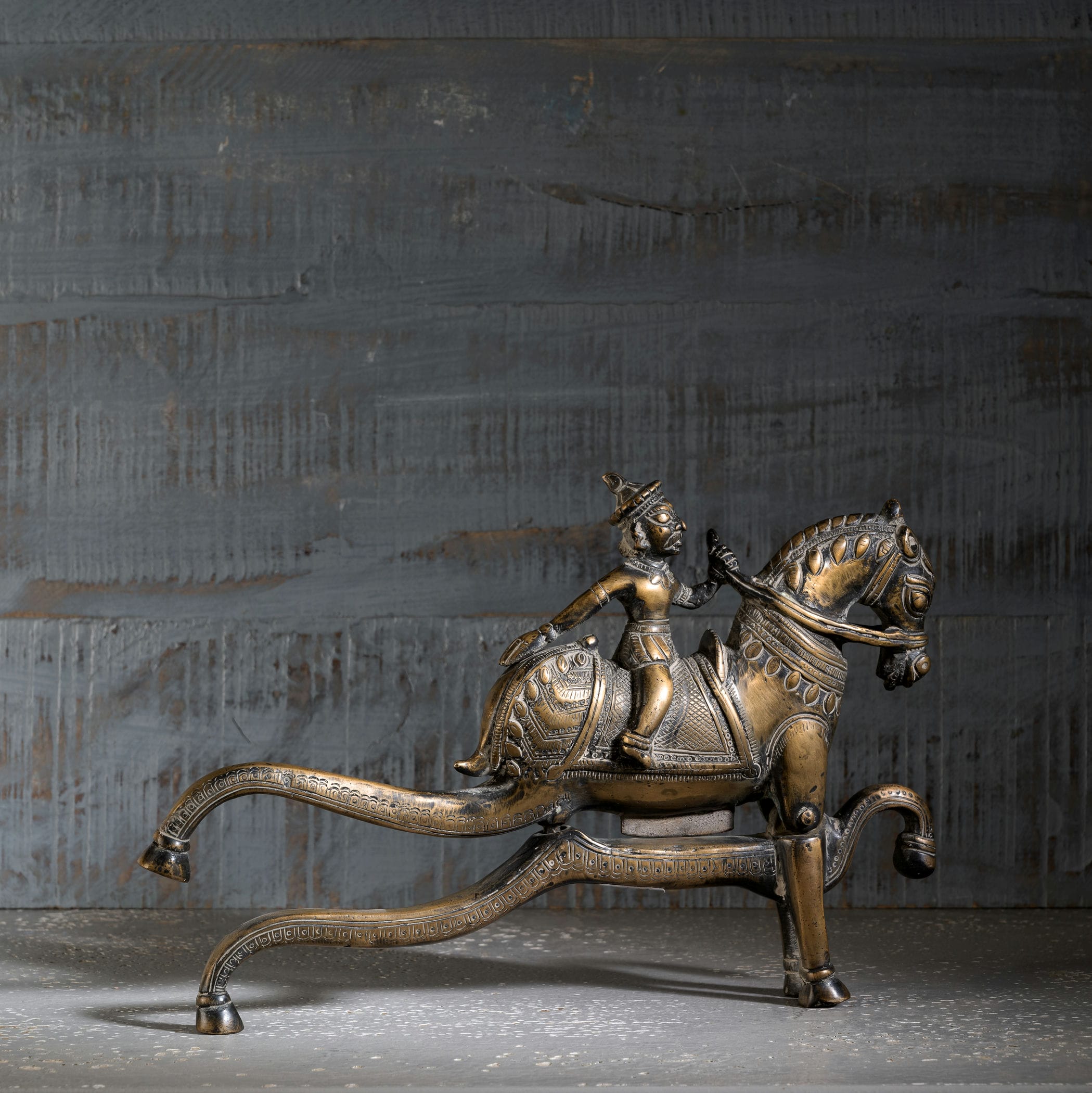 Antique Brass Horse Nutcracker showing mechanical grandeur on a living room coffee table. 