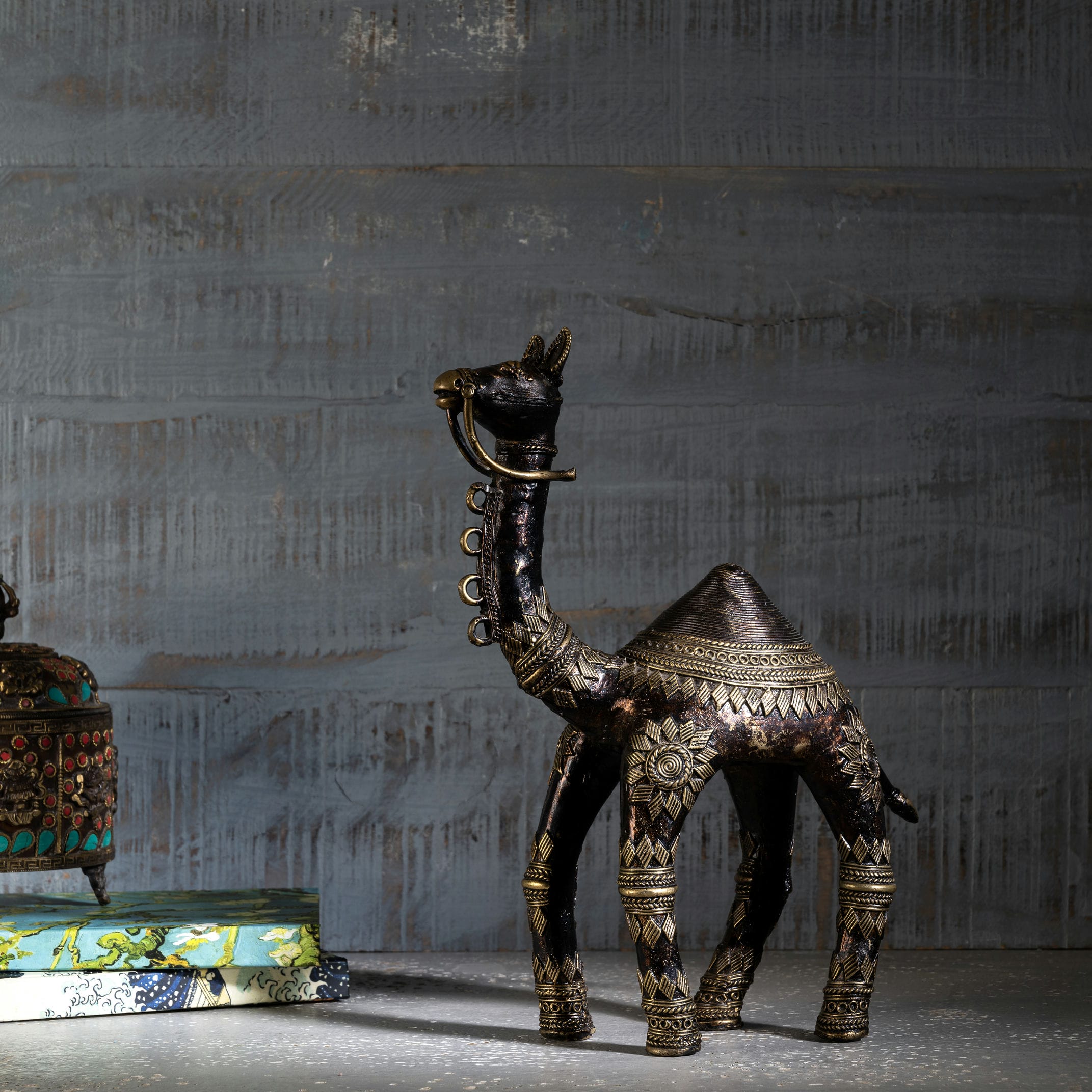 Rajasthani metal animal art featuring polished gold-tone sunburst motifs for an executive desk or corporate gifting.