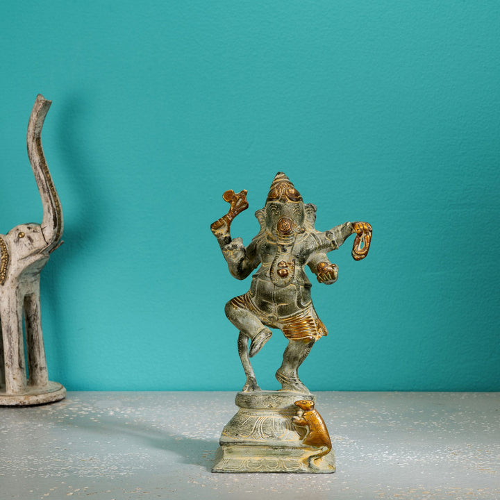 Verdigris Brass Dancing Ganesha Statue balancing effortlessly on a prominent entryway console. 