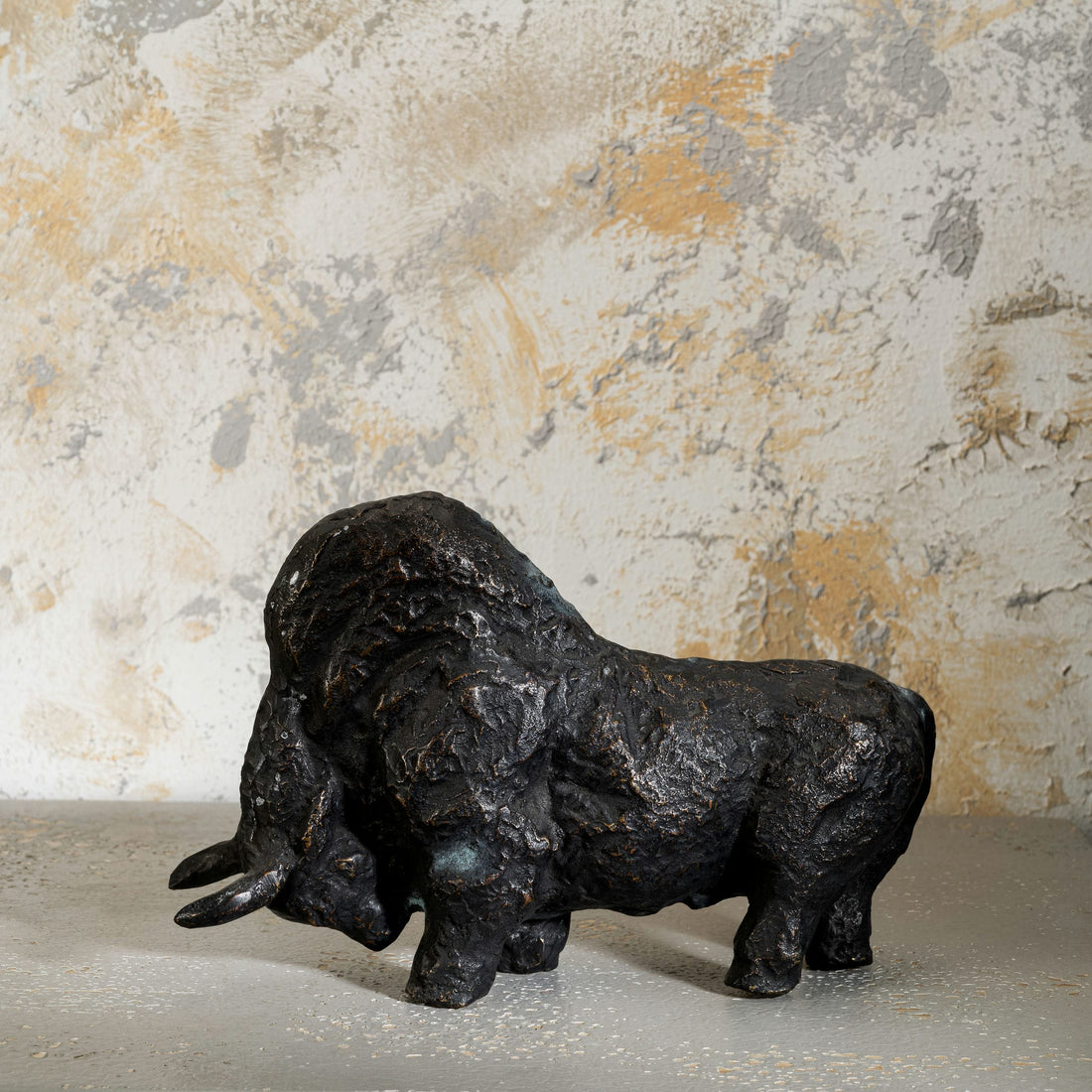 Abstract heavy metal animal figurine highlighting deep cratered surface patterns for a minimalist concrete 