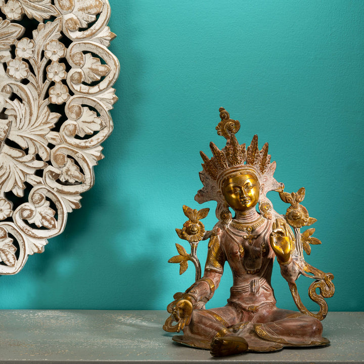 Handcrafted metal Buddhist goddess sculpture with polished golden highlights for a meditation space or spiritual sanctuary.
