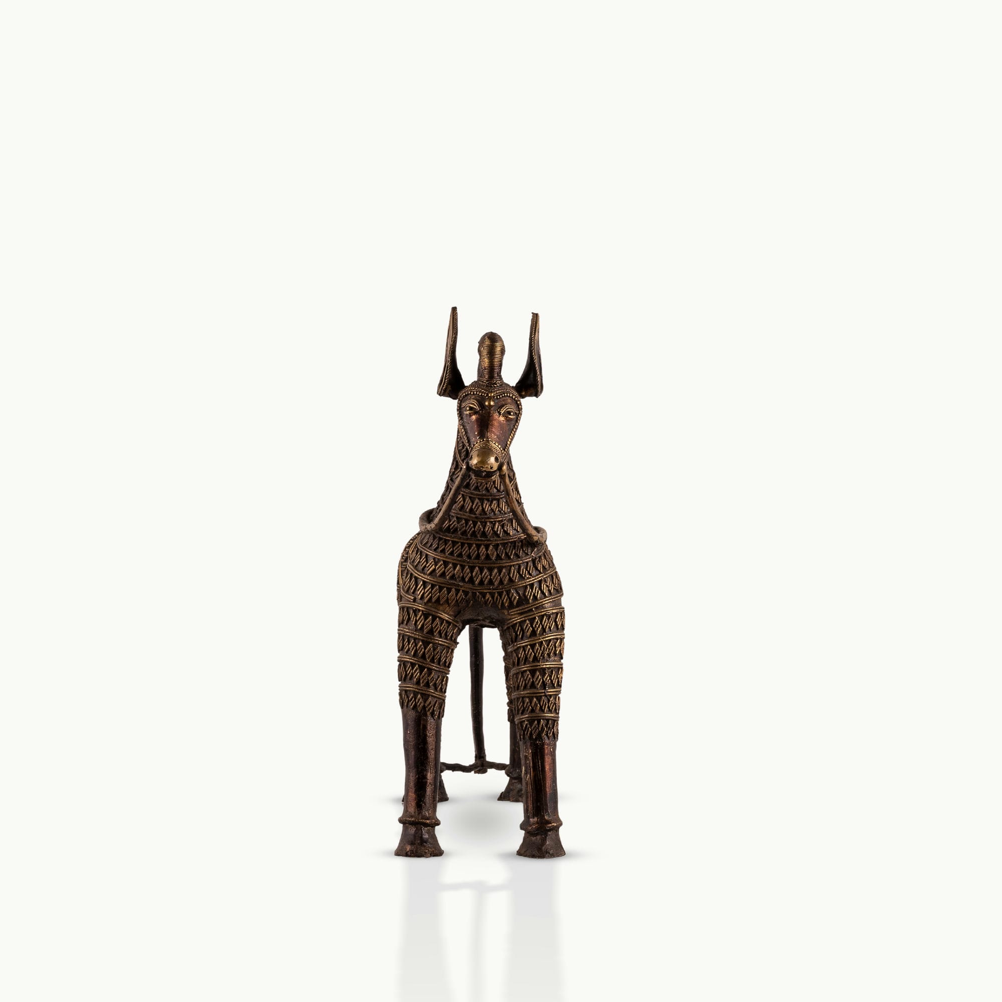 Monumental Antique Brass Horse Sculpture standing rigidly on a reclaimed wood console. 