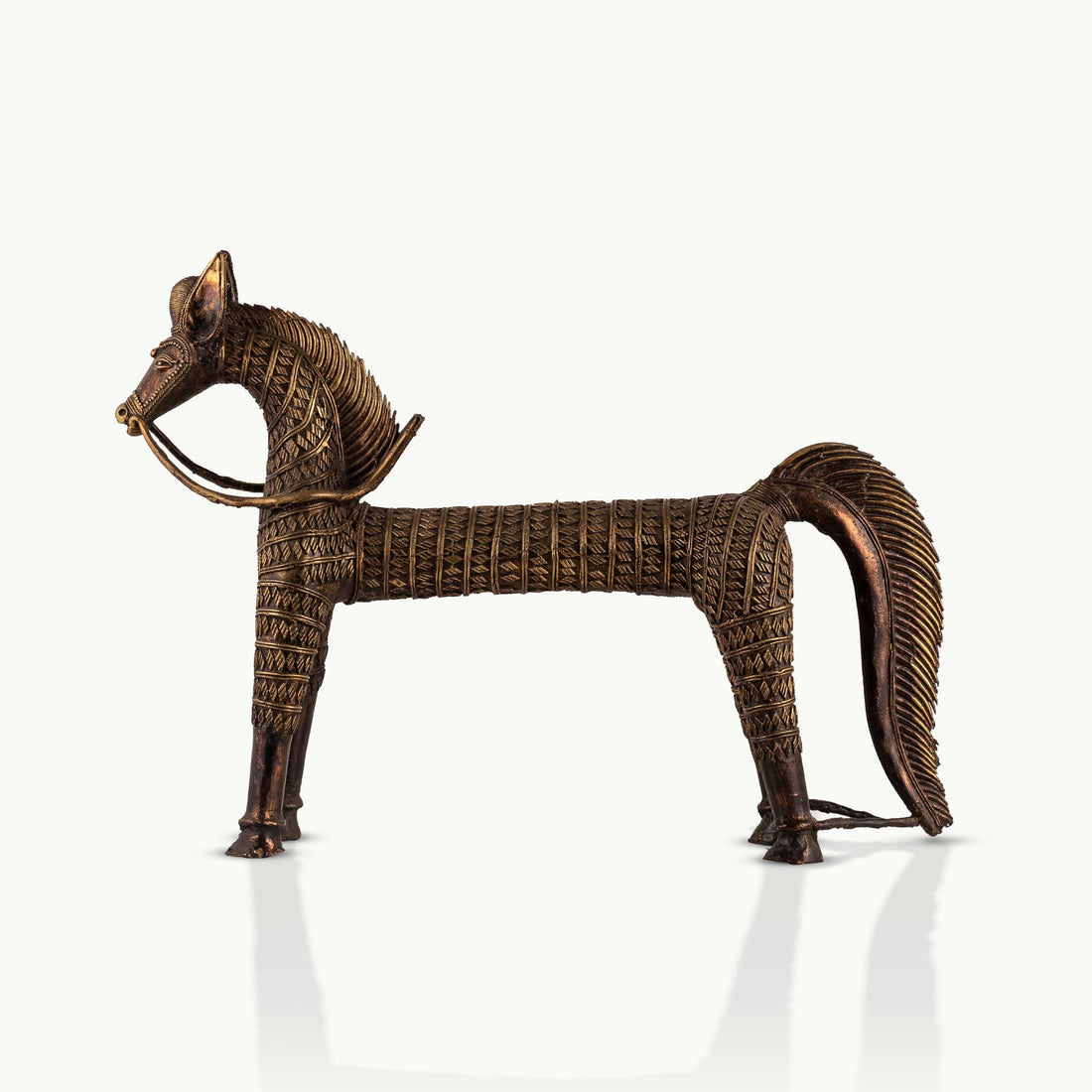 Monumental Antique Brass Horse Sculpture standing rigidly on a reclaimed wood console. 