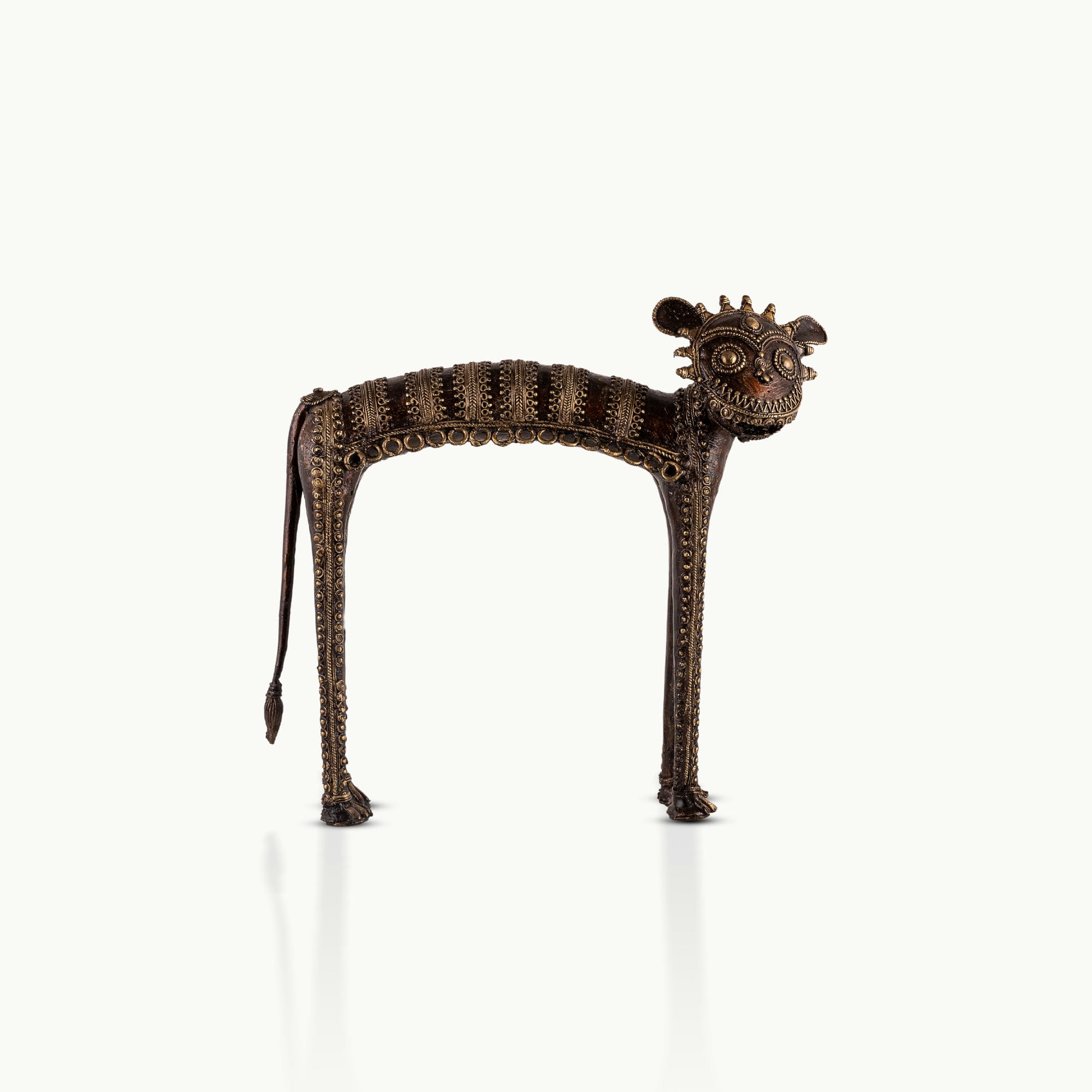 Dhokra Brass Tribal Feline Sculpture staring fiercely on a minimalist concrete credenza. 