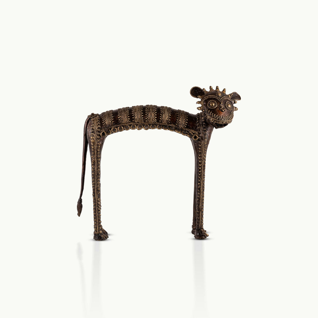 Dhokra Brass Tribal Feline Sculpture staring fiercely on a minimalist concrete credenza. 