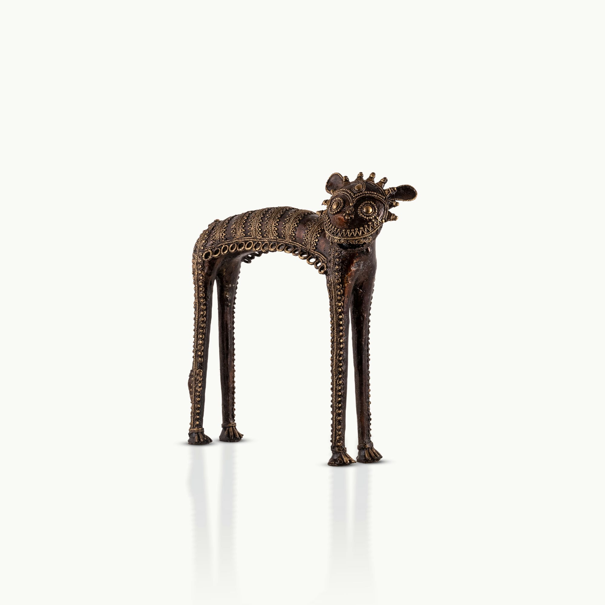 Dhokra Brass Tribal Feline Sculpture staring fiercely on a minimalist concrete credenza. 