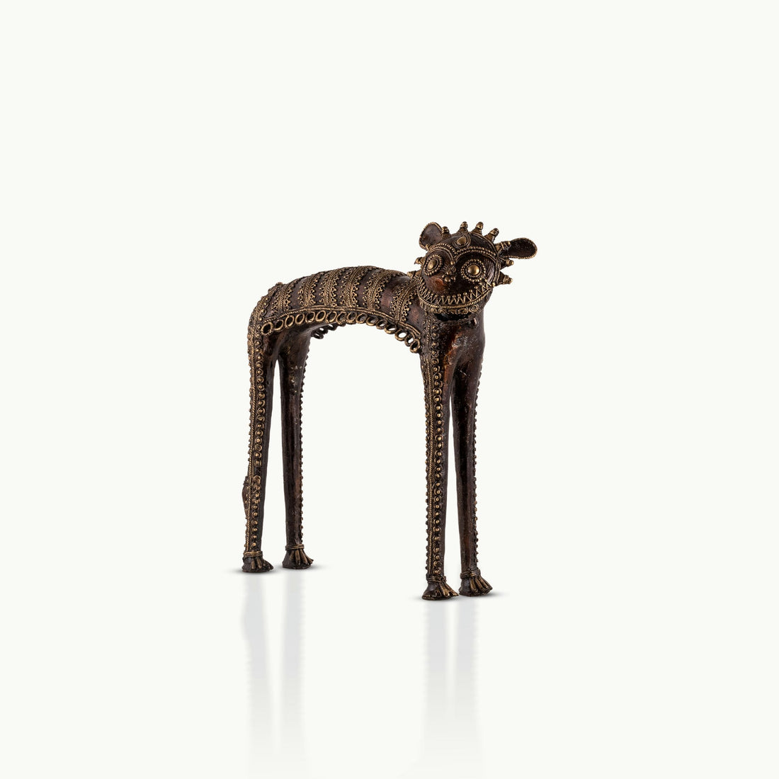 Dhokra Brass Tribal Feline Sculpture staring fiercely on a minimalist concrete credenza. 