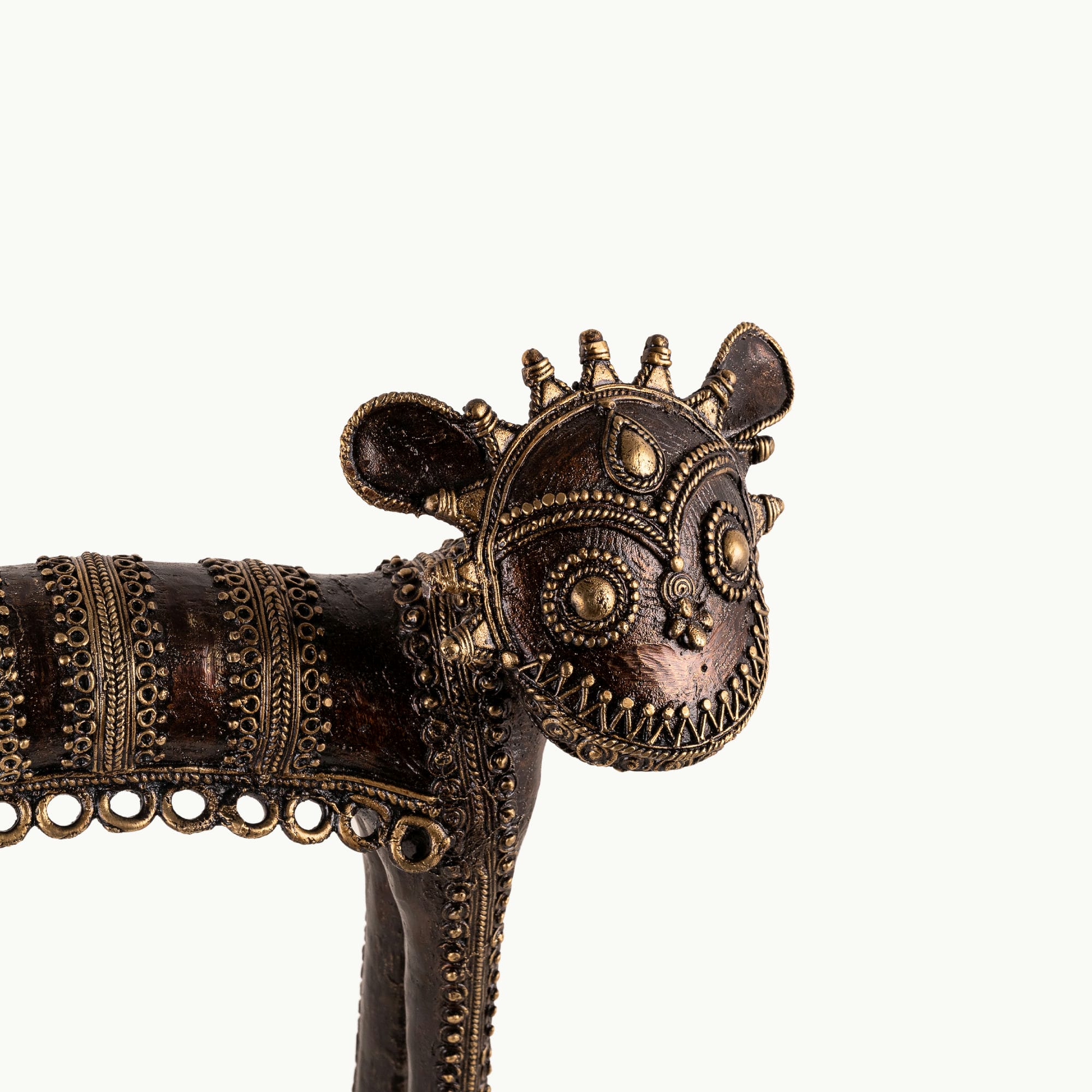 Dhokra Brass Tribal Feline Sculpture staring fiercely on a minimalist concrete credenza. 