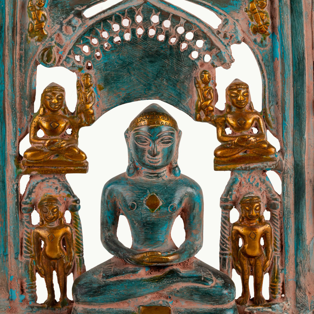 Verdigris Brass Tirthankara Panel surrounded by miniature deities on an east-facing puja altar
