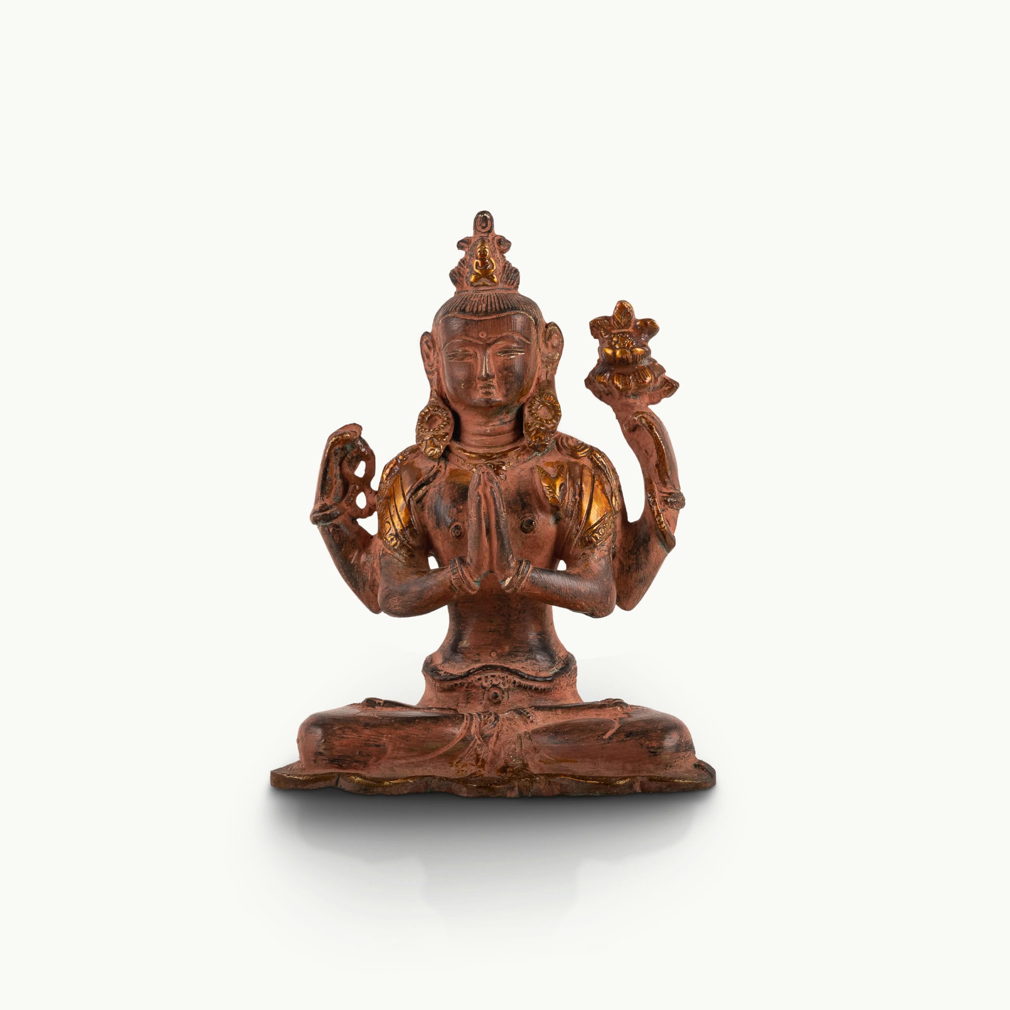 Red Oxidized Brass Tara Statue showing four arms of compassion on an east-facing meditation altar. 