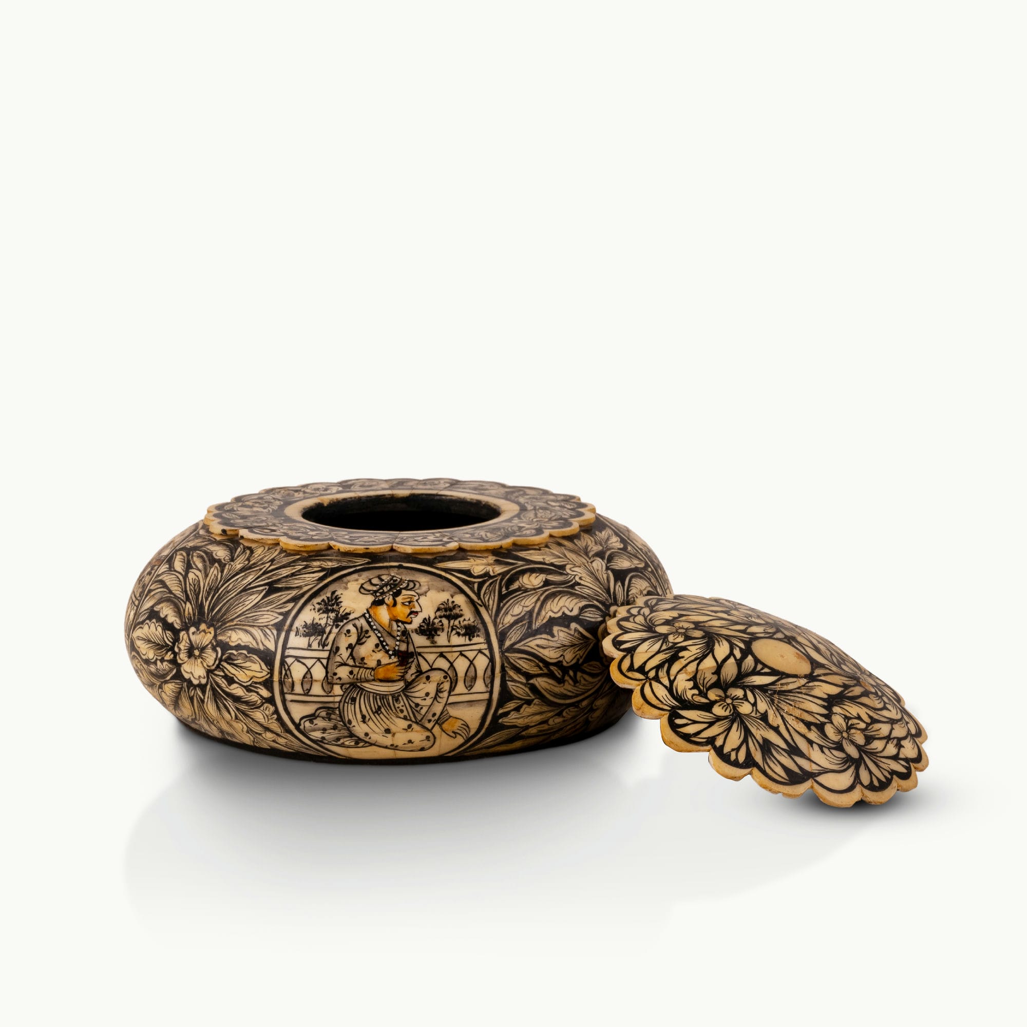 Black etched camel bone box showing carved Rajput court musicians on a dark oak dressing table. 
