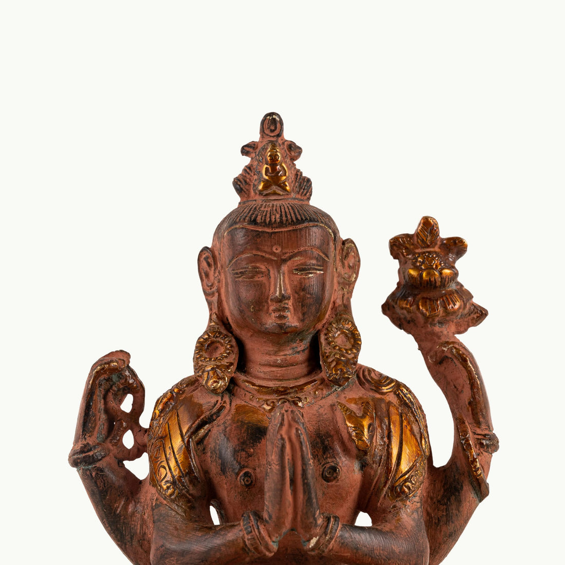 Red Oxidized Brass Tara Statue showing four arms of compassion on an east-facing meditation altar. 
