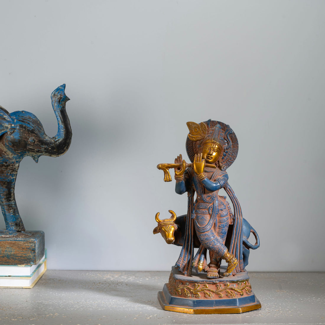 Black Brass Tribal Head Sculpture projecting an ancestral presence on a floating gallery shelf. 