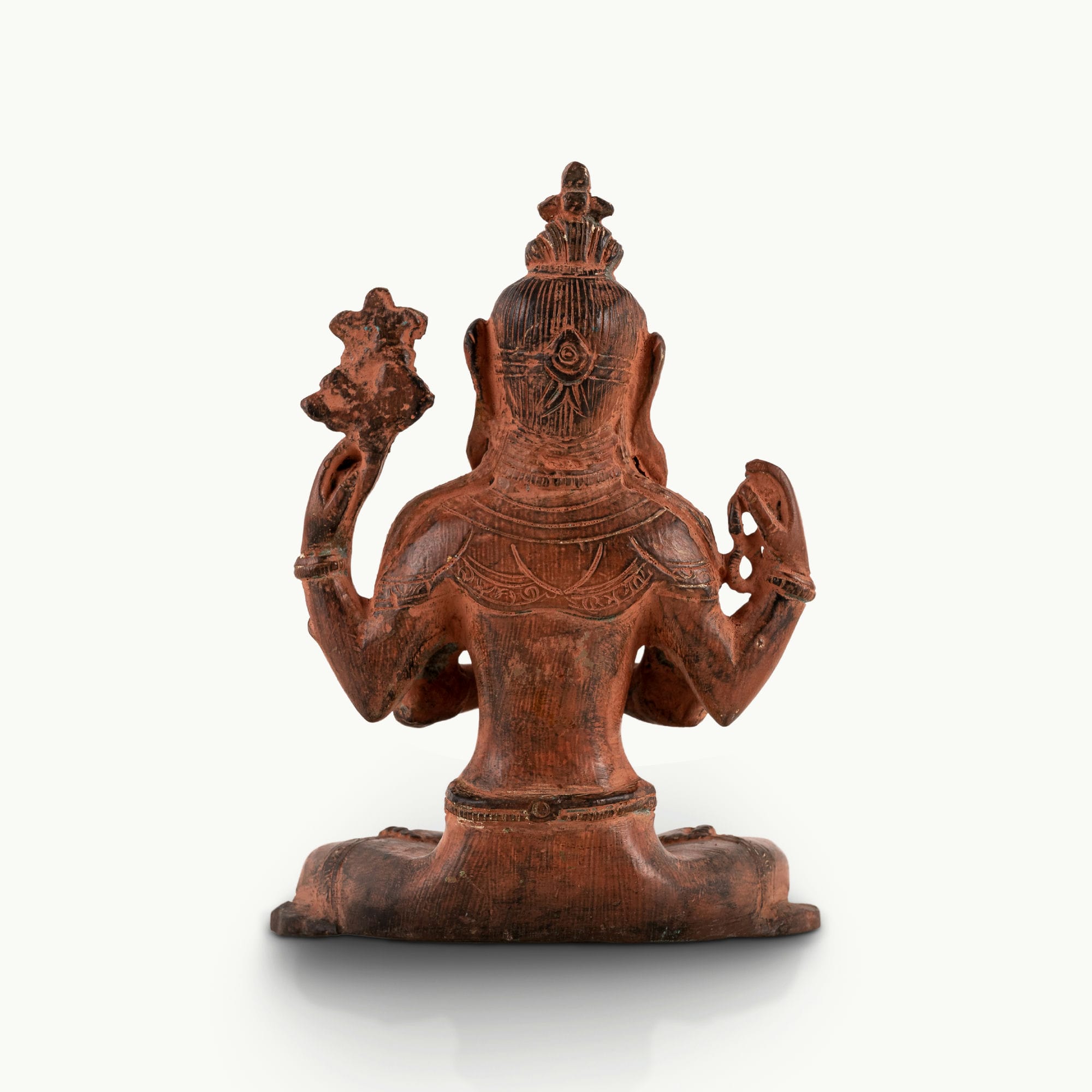 Red Oxidized Brass Tara Statue showing four arms of compassion on an east-facing meditation altar. 