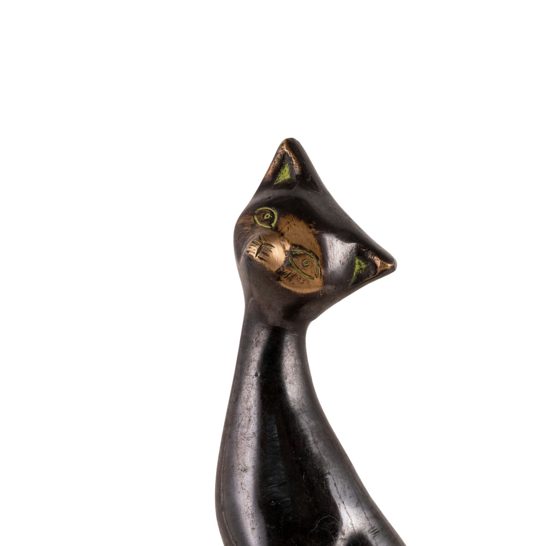 Stylized Black Brass Cat Sculpture projecting stark modernist lines on a minimalist concrete bookshelf. 