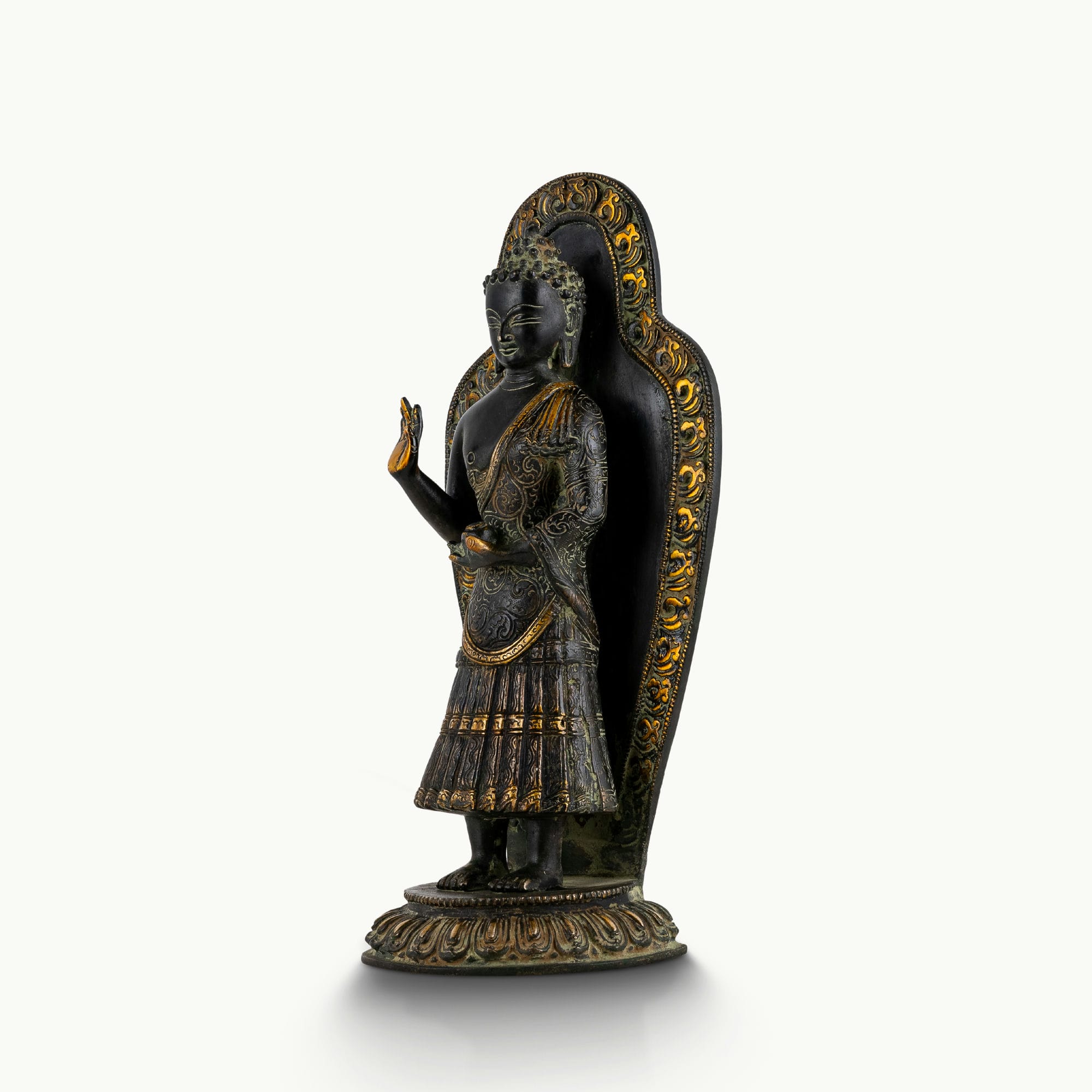 Black brass standing Buddha statue with a detailed mandorla halo.