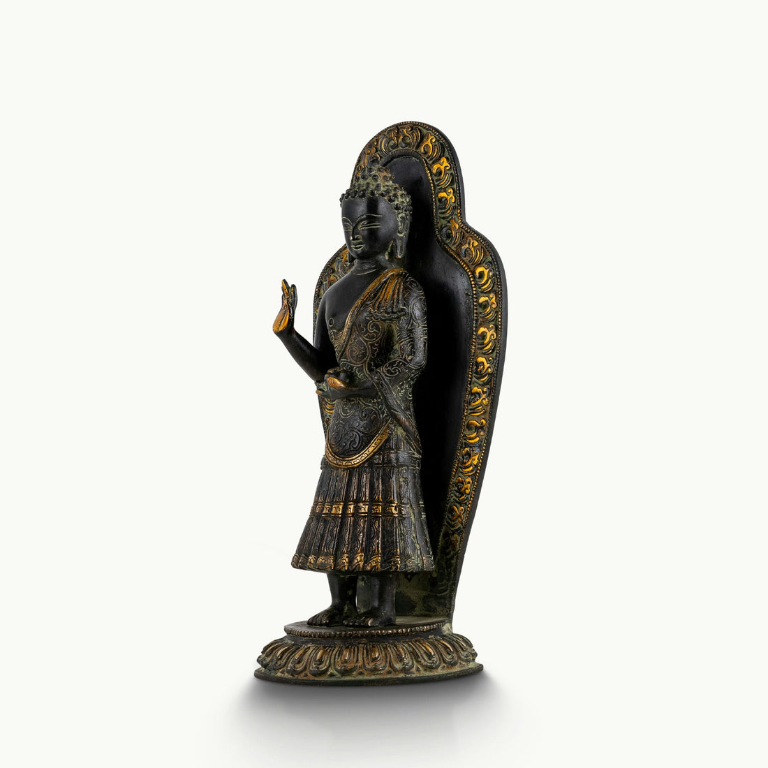 Black brass standing Buddha statue with a detailed mandorla halo.