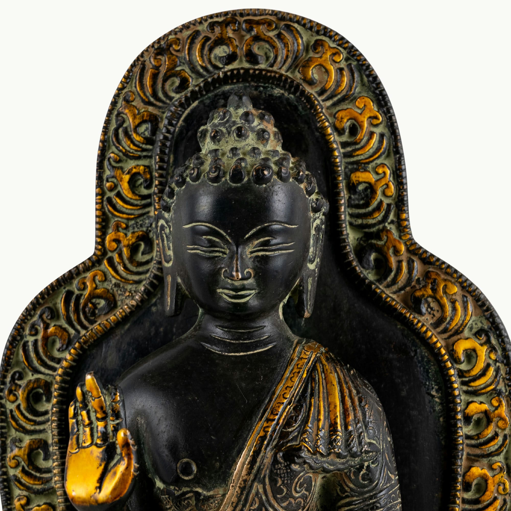 Black brass standing Buddha statue with a detailed mandorla halo.