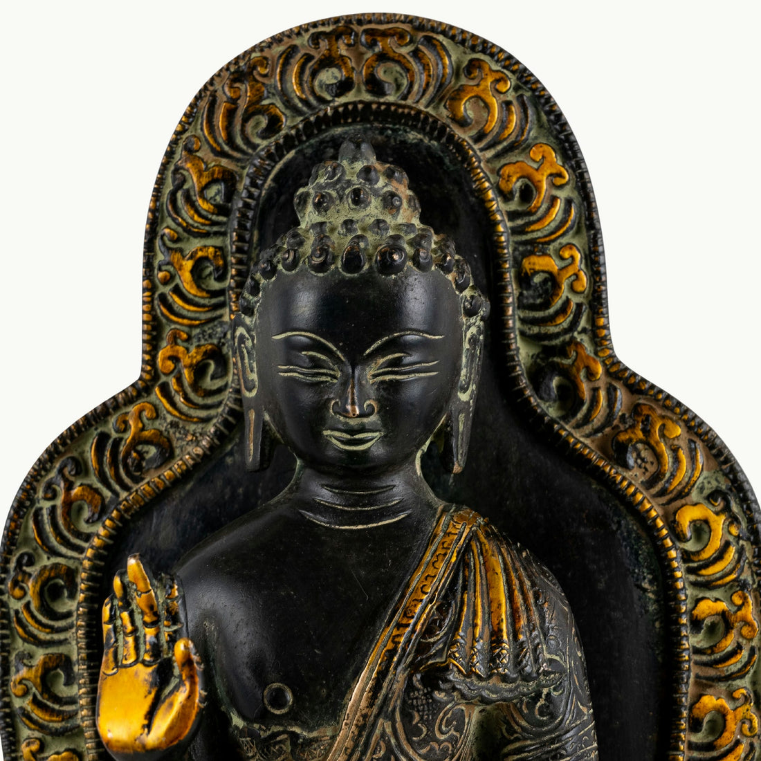 Black brass standing Buddha statue with a detailed mandorla halo.