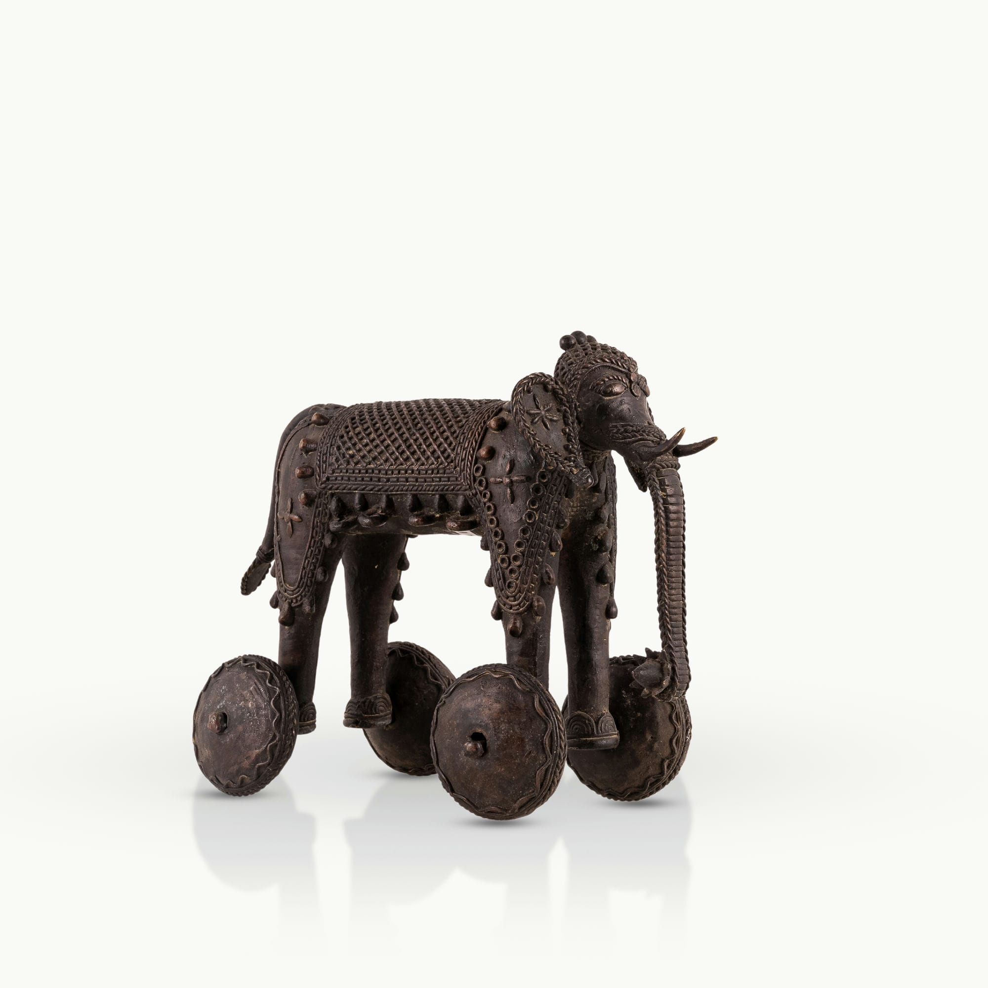 Dhokra Brass Wheeled Elephant ready for a ceremonial procession on a reclaimed wood coffee table. 