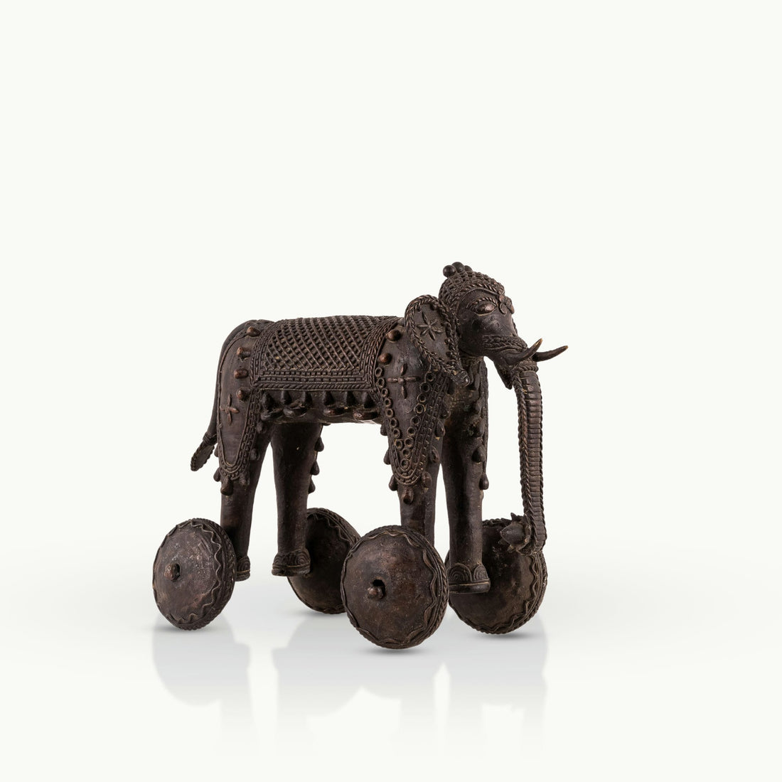 Dhokra Brass Wheeled Elephant ready for a ceremonial procession on a reclaimed wood coffee table. 