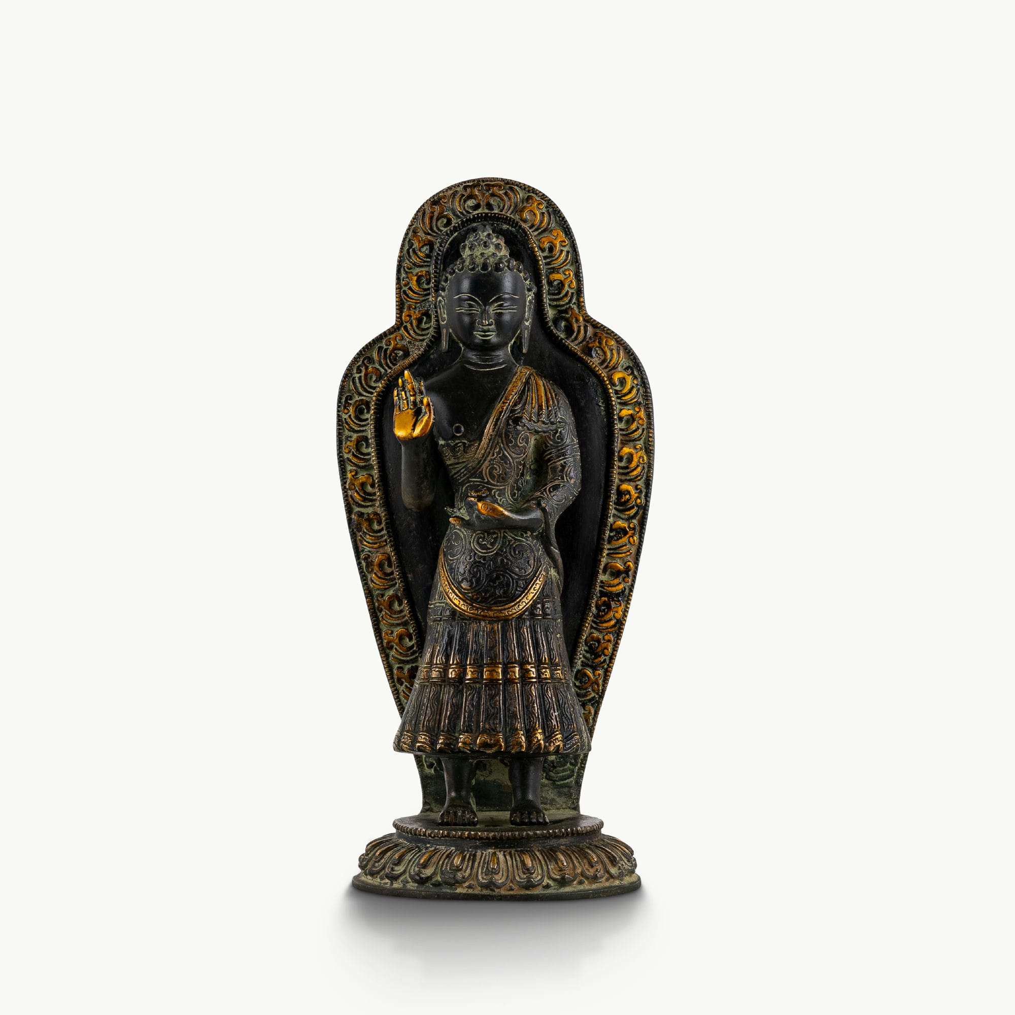 Black brass standing Buddha statue with a detailed mandorla halo.