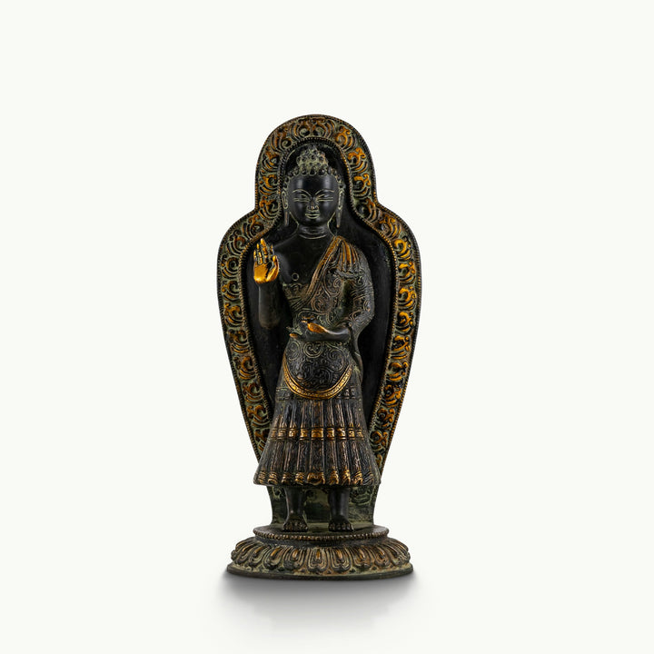 Black brass standing Buddha statue with a detailed mandorla halo.