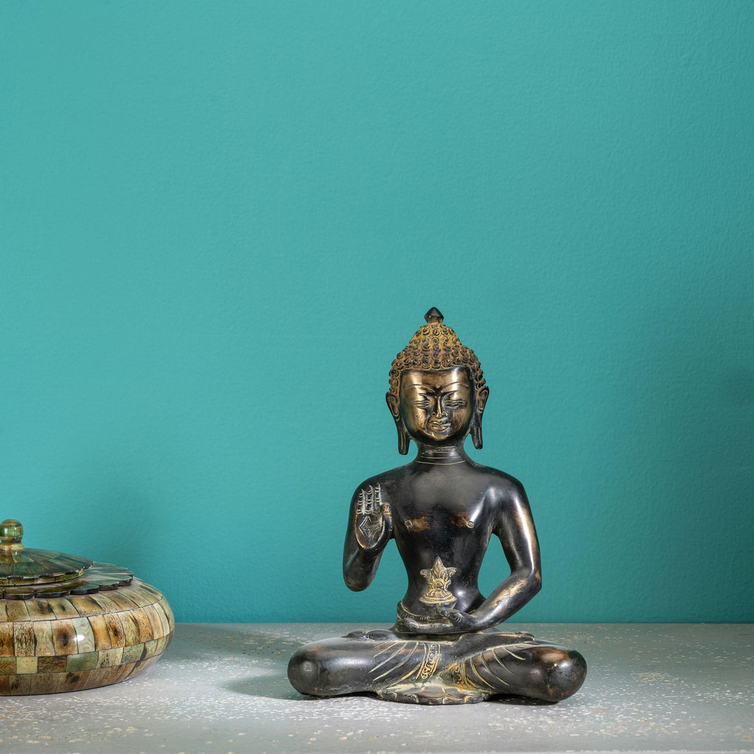 Brass buddha in sitting position
