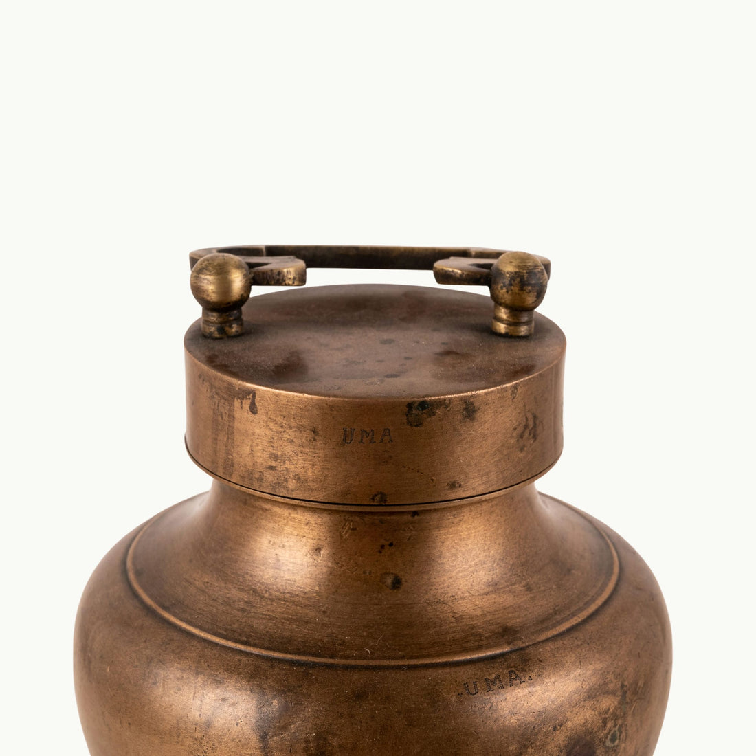 Antique Brass Locking Urn equipped with a dual-pin lid for a rustic reclaimed wood console.