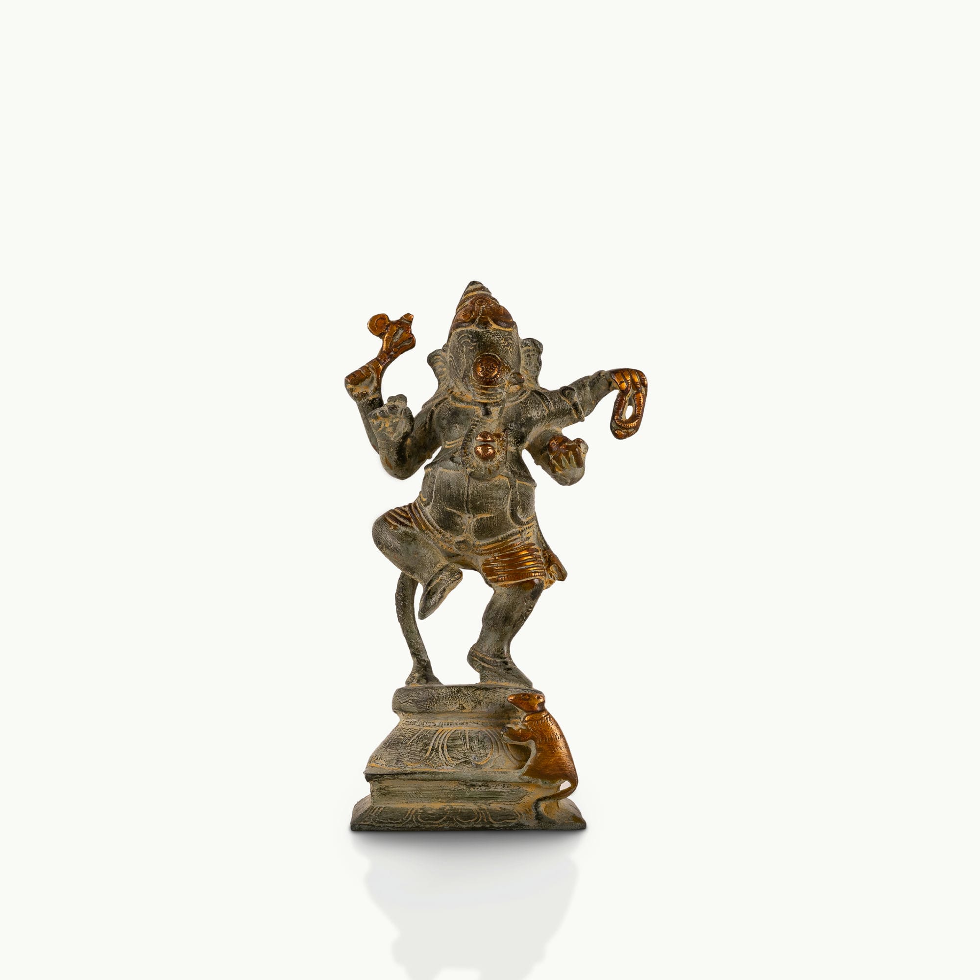 Verdigris Brass Dancing Ganesha Statue balancing effortlessly on a prominent entryway console. 