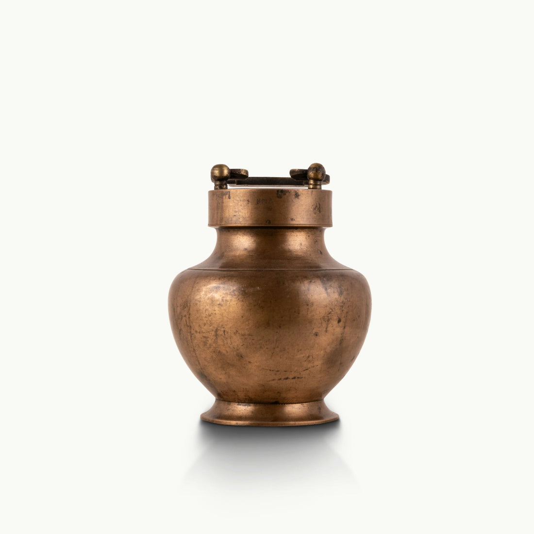 Antique Brass Locking Urn equipped with a dual-pin lid for a rustic reclaimed wood console.