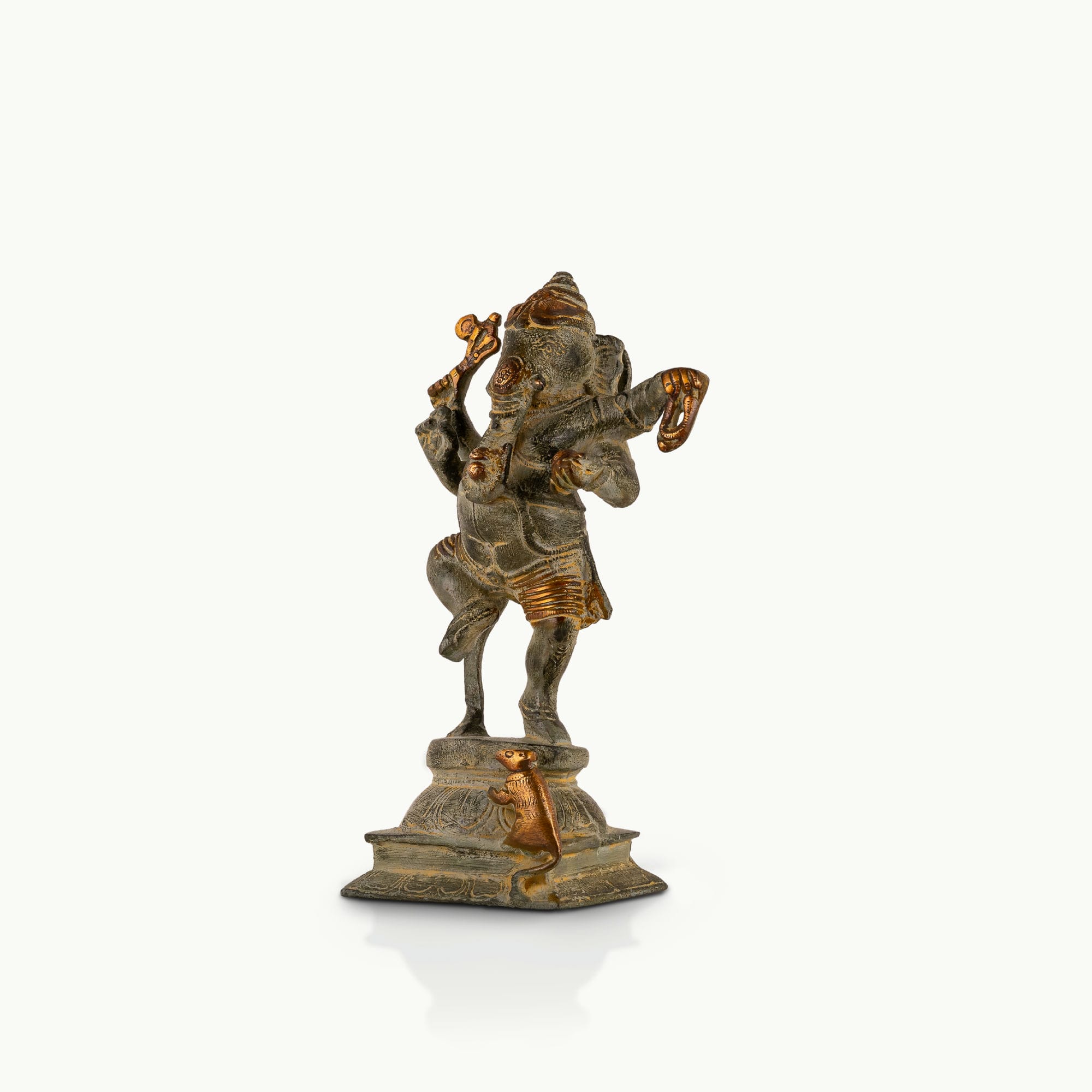 Verdigris Brass Dancing Ganesha Statue balancing effortlessly on a prominent entryway console. 