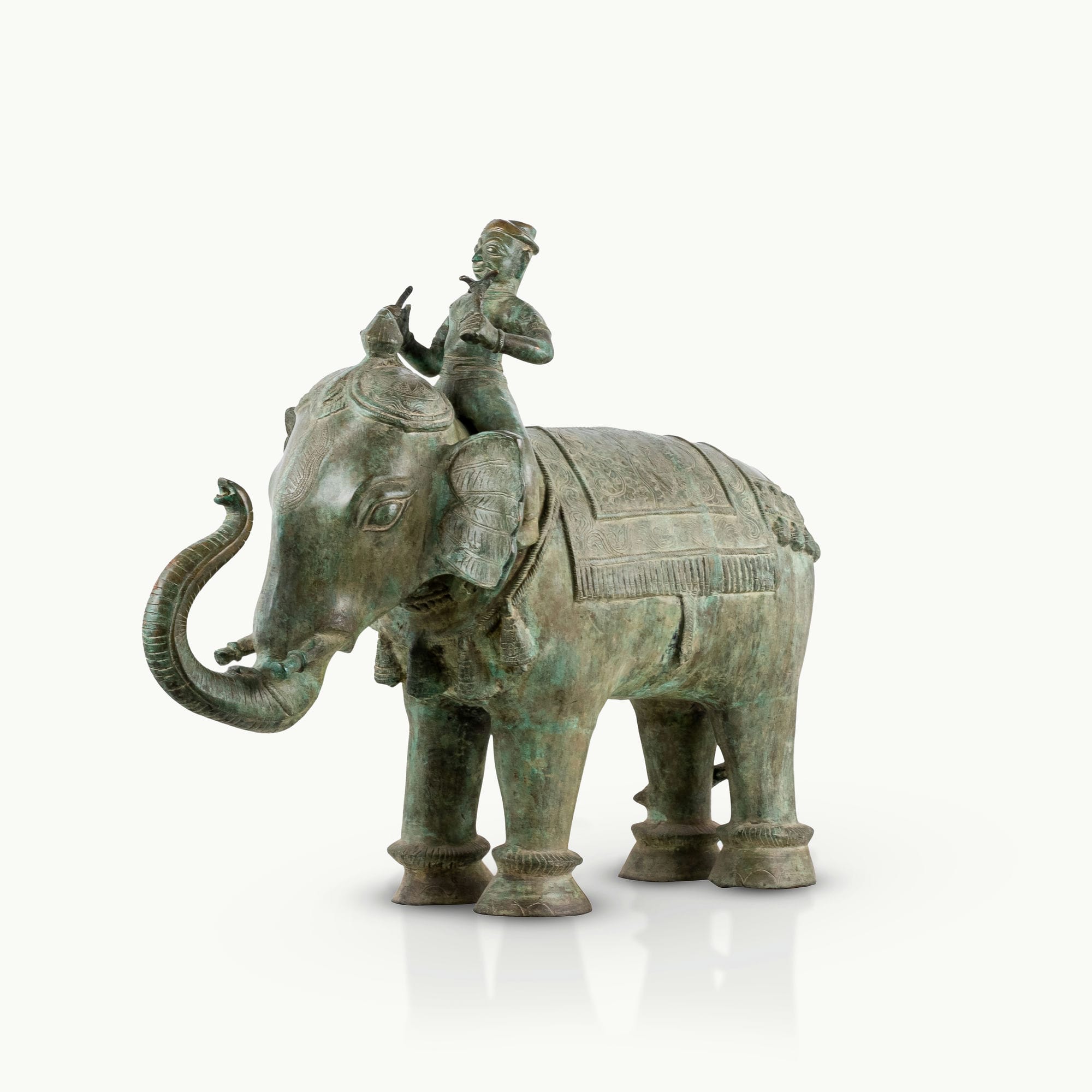Antiqued brass elephant rider sculpture featuring a verdigris caparison.