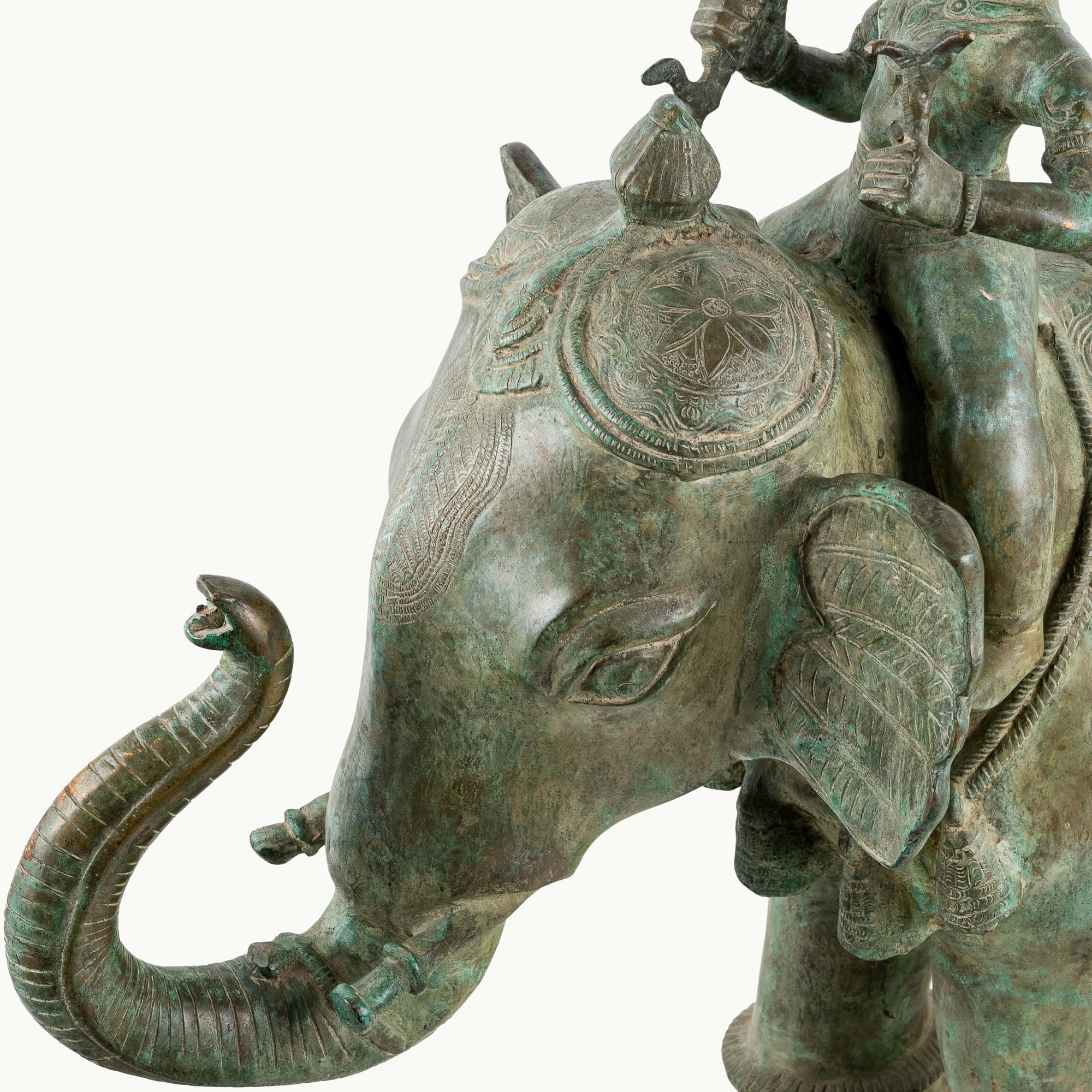 Antiqued brass elephant rider sculpture featuring a verdigris caparison.
