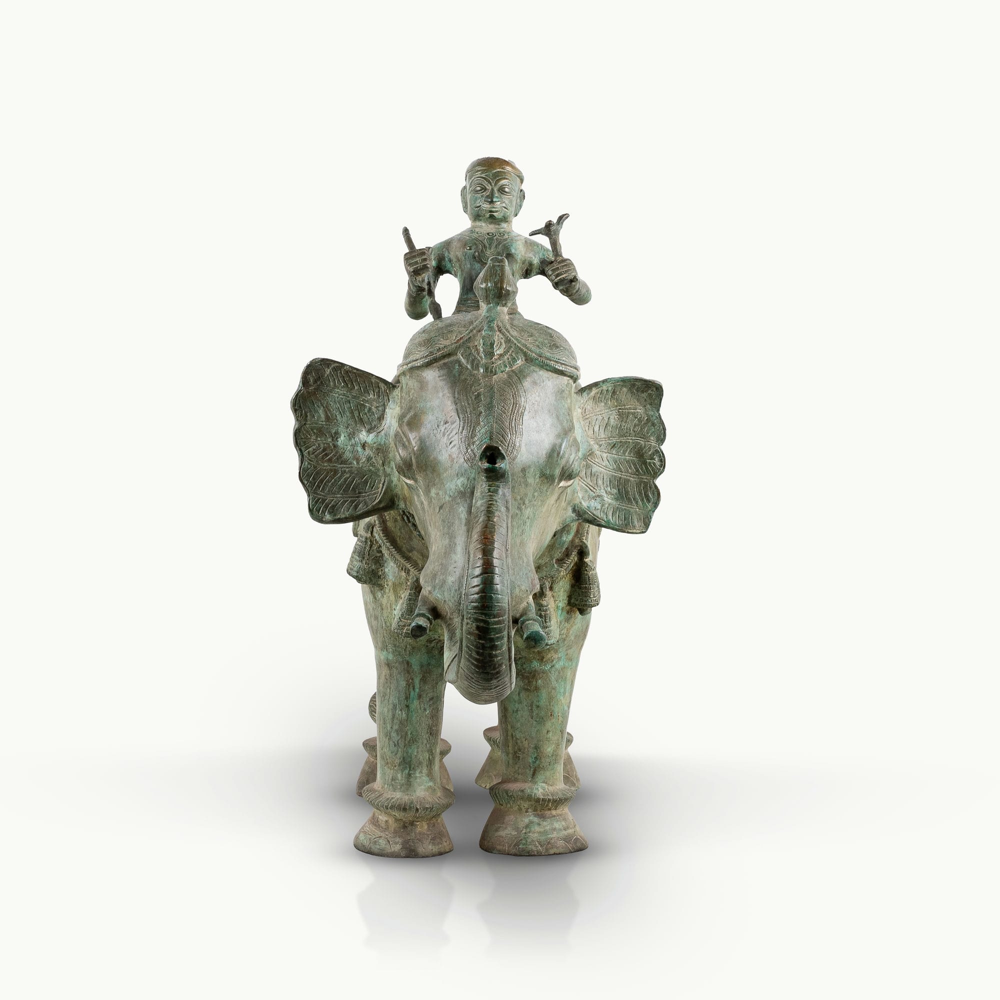 Antiqued brass elephant rider sculpture featuring a verdigris caparison.