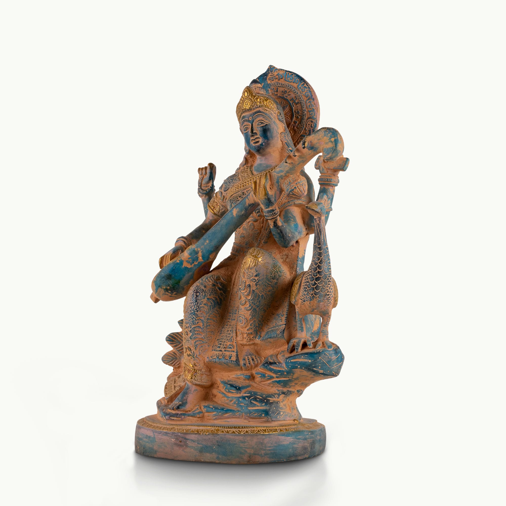 Dual-Tone Brass Saraswati Statue cradling a veena gracefully on a dedicated library console. 