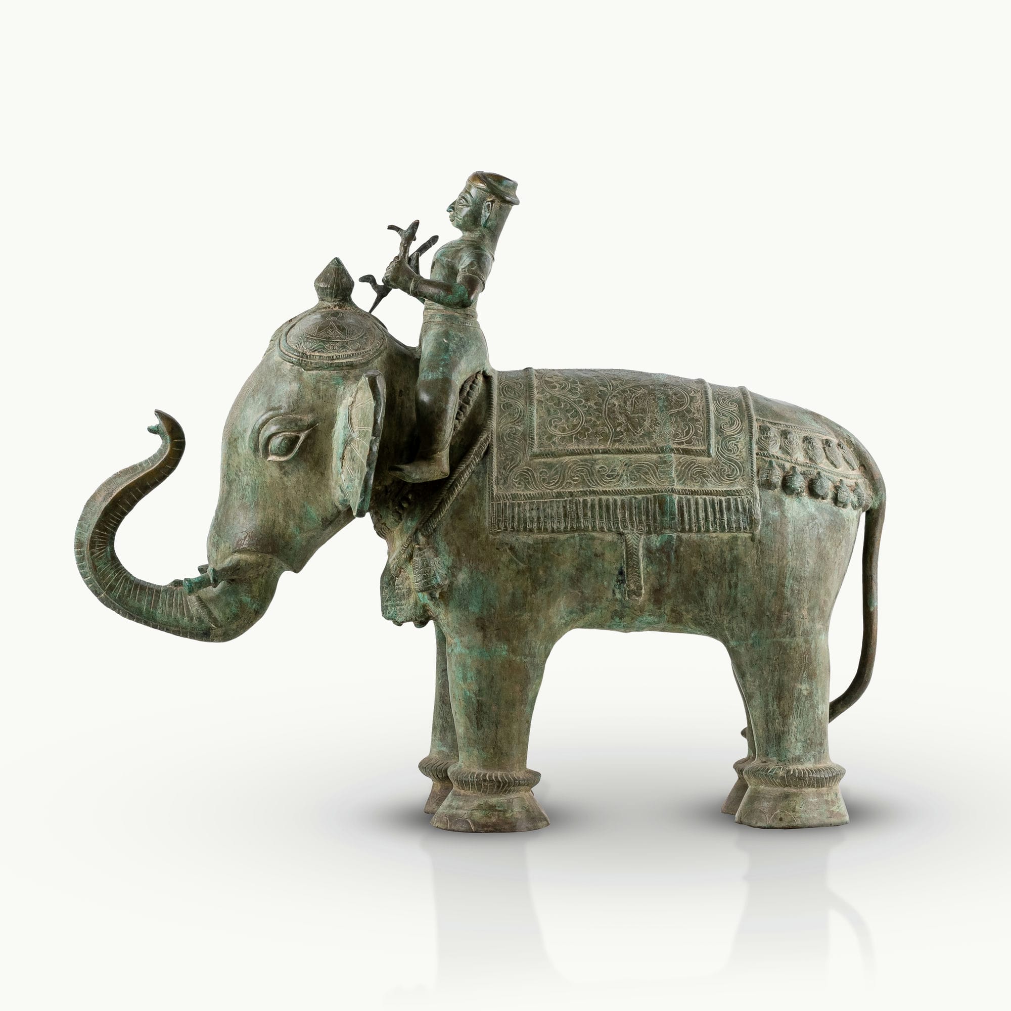 Antiqued brass elephant rider sculpture featuring a verdigris caparison.