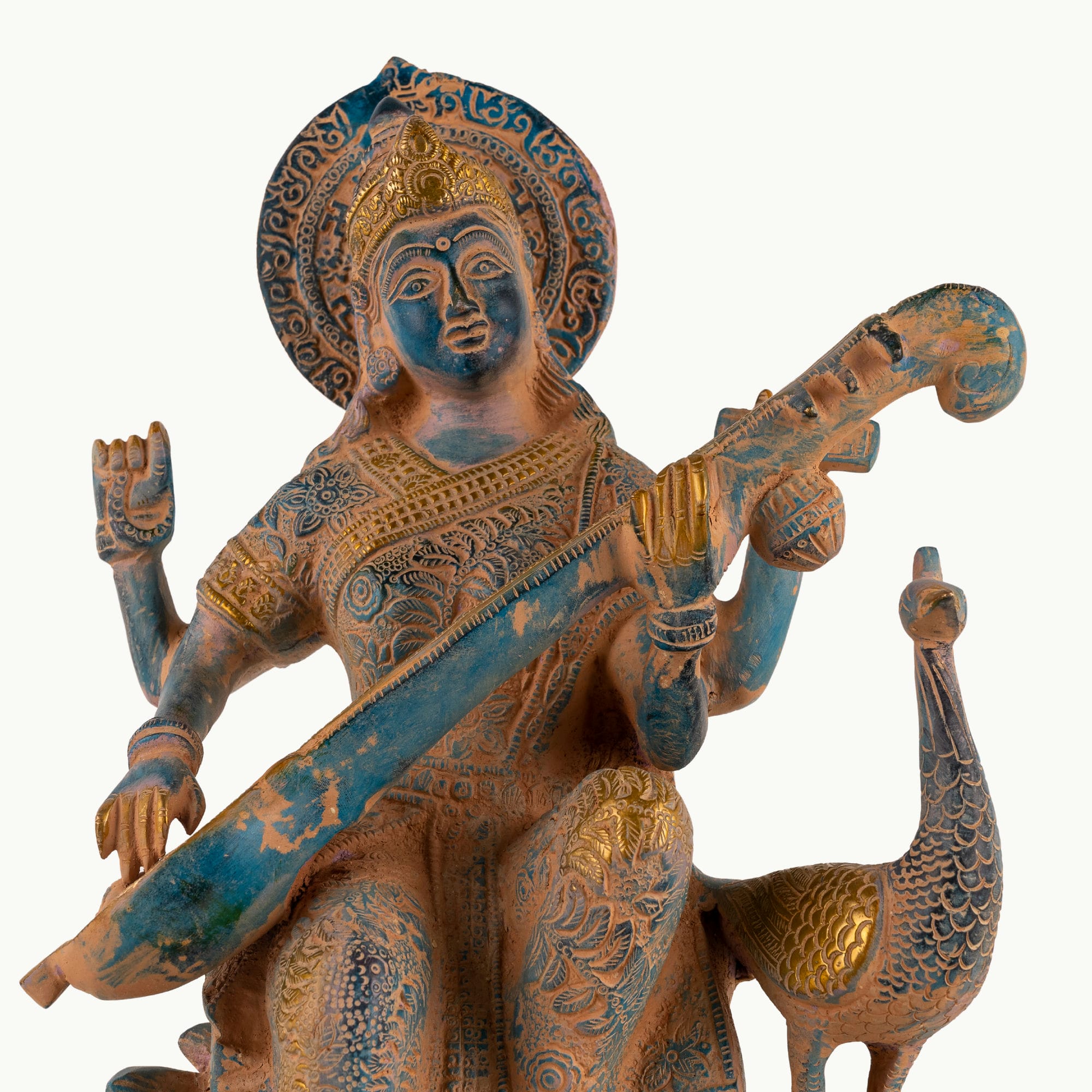 Dual-Tone Brass Saraswati Statue cradling a veena gracefully on a dedicated library console. 