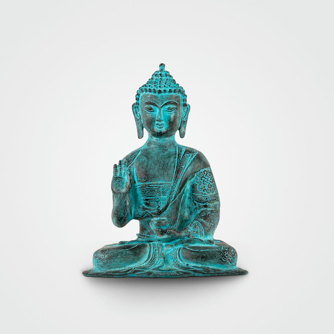 Verdigris Brass Abhaya Buddha Statue radiating fearlessness for a living room mantle. 