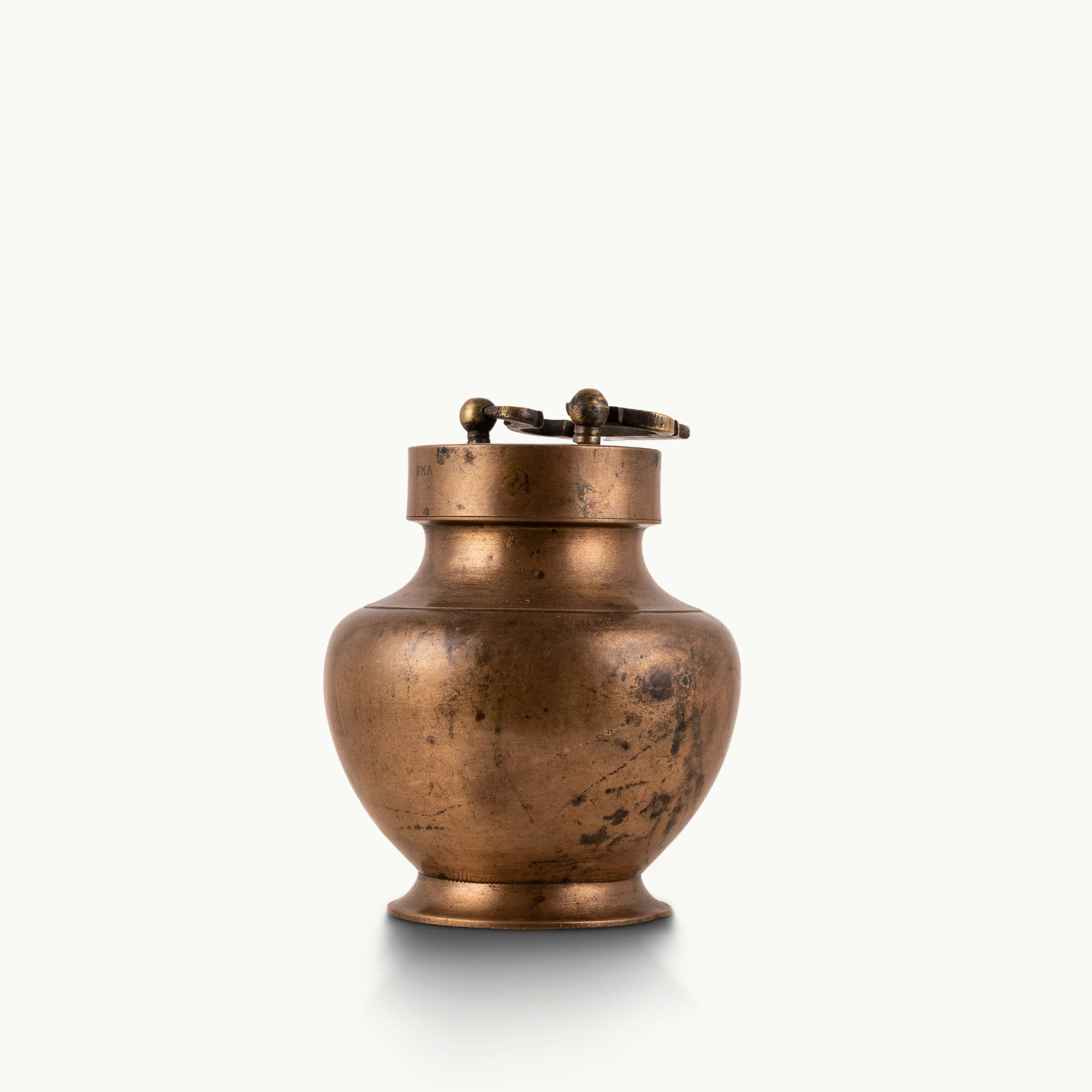 Antique Brass Locking Urn equipped with a dual-pin lid for a rustic reclaimed wood console.