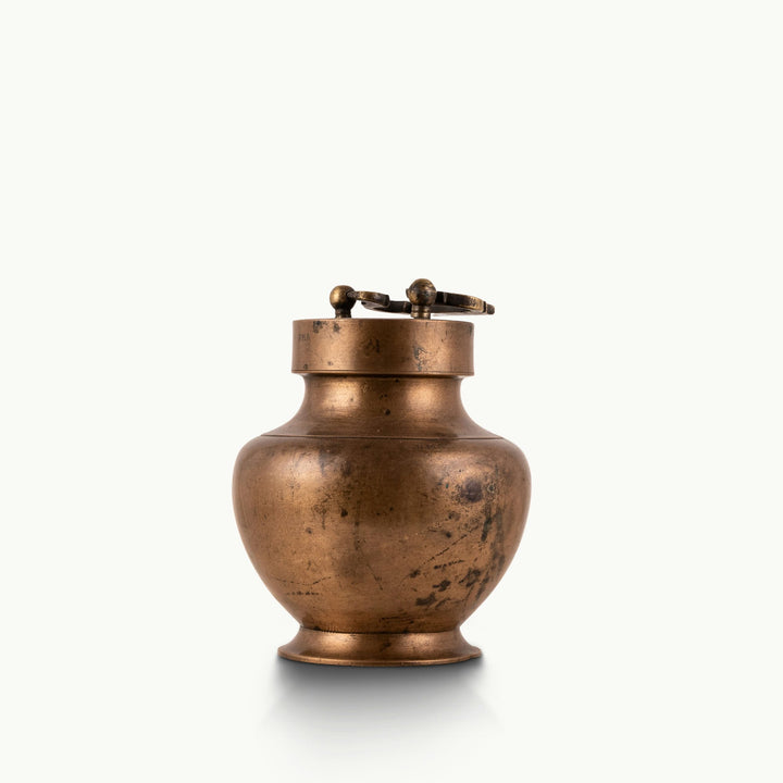 Antique Brass Locking Urn equipped with a dual-pin lid for a rustic reclaimed wood console.
