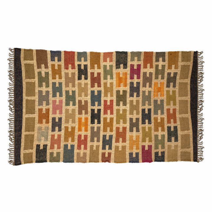 Stepped mosaic wool jute dhurrie in a living room, with rust terracotta and chocolate brown diamonds. 