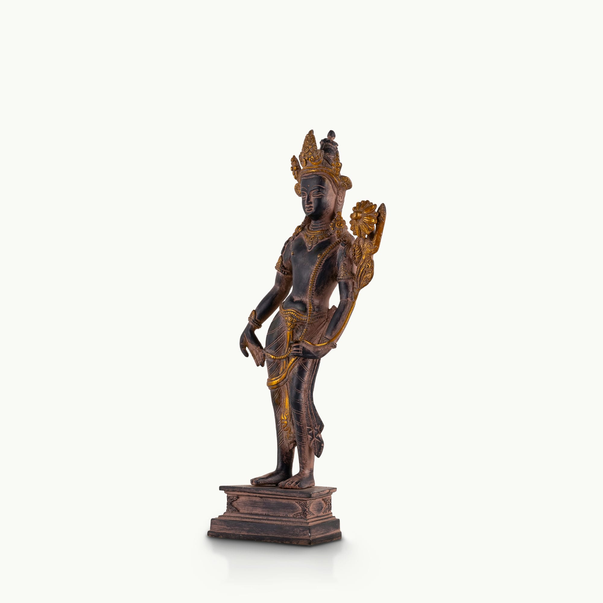 Dual-Tone Brass Padmapani Statue holding a blooming lotus stem on a minimalist entryway console. 
