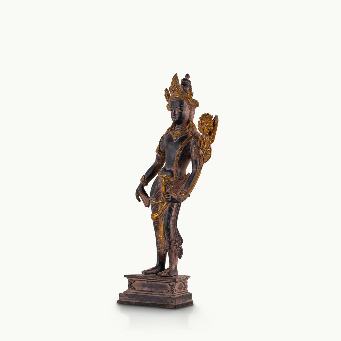 Dual-Tone Brass Padmapani Statue holding a blooming lotus stem on a minimalist entryway console. 