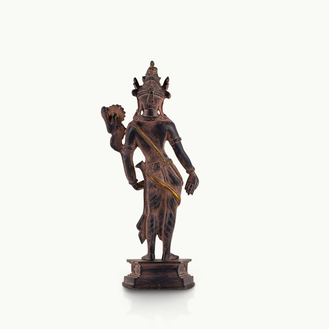 Dual-Tone Brass Padmapani Statue holding a blooming lotus stem on a minimalist entryway console. 