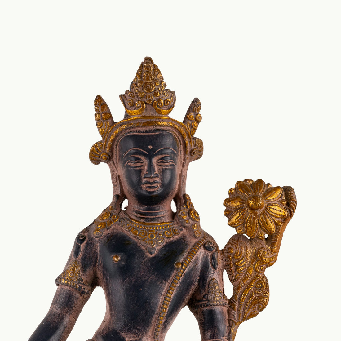 Dual-Tone Brass Padmapani Statue holding a blooming lotus stem on a minimalist entryway console. 