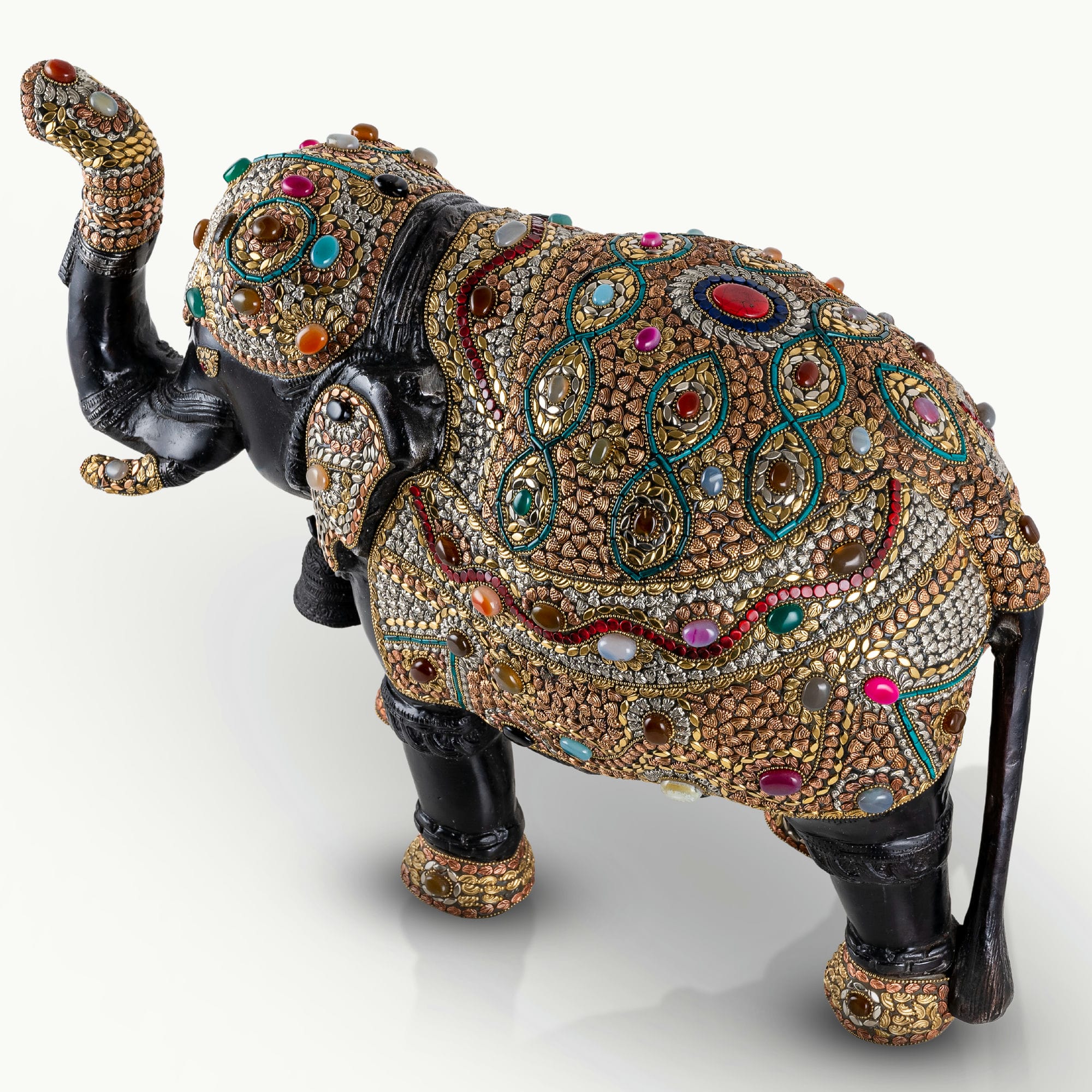 Stone inlay brass elephant sculpture featuring turquoise and lapis accents.