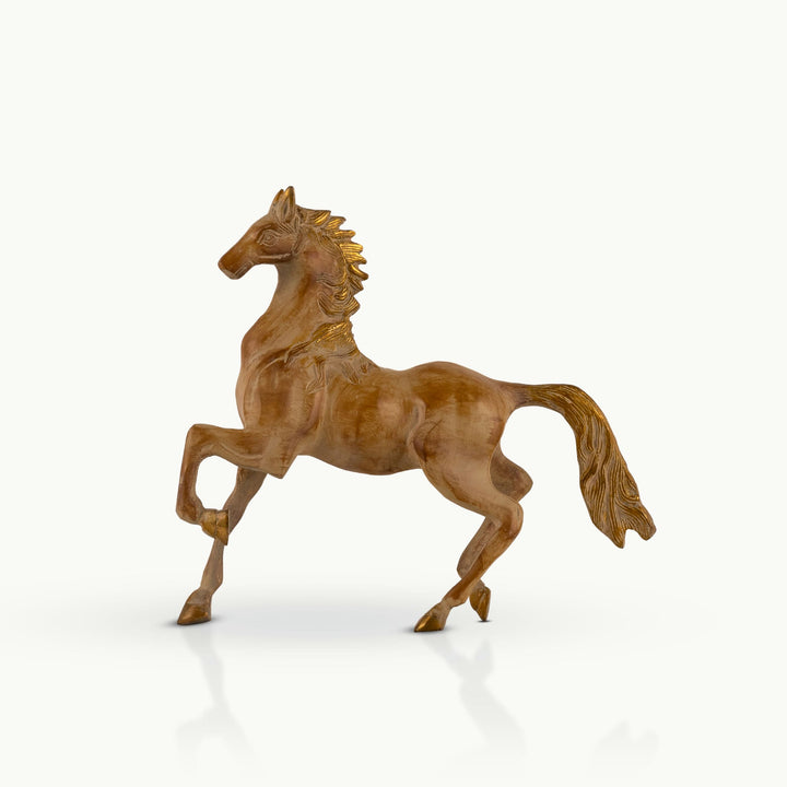 Stylized brass horse sculpture in a trotting posture with a pale golden finish.