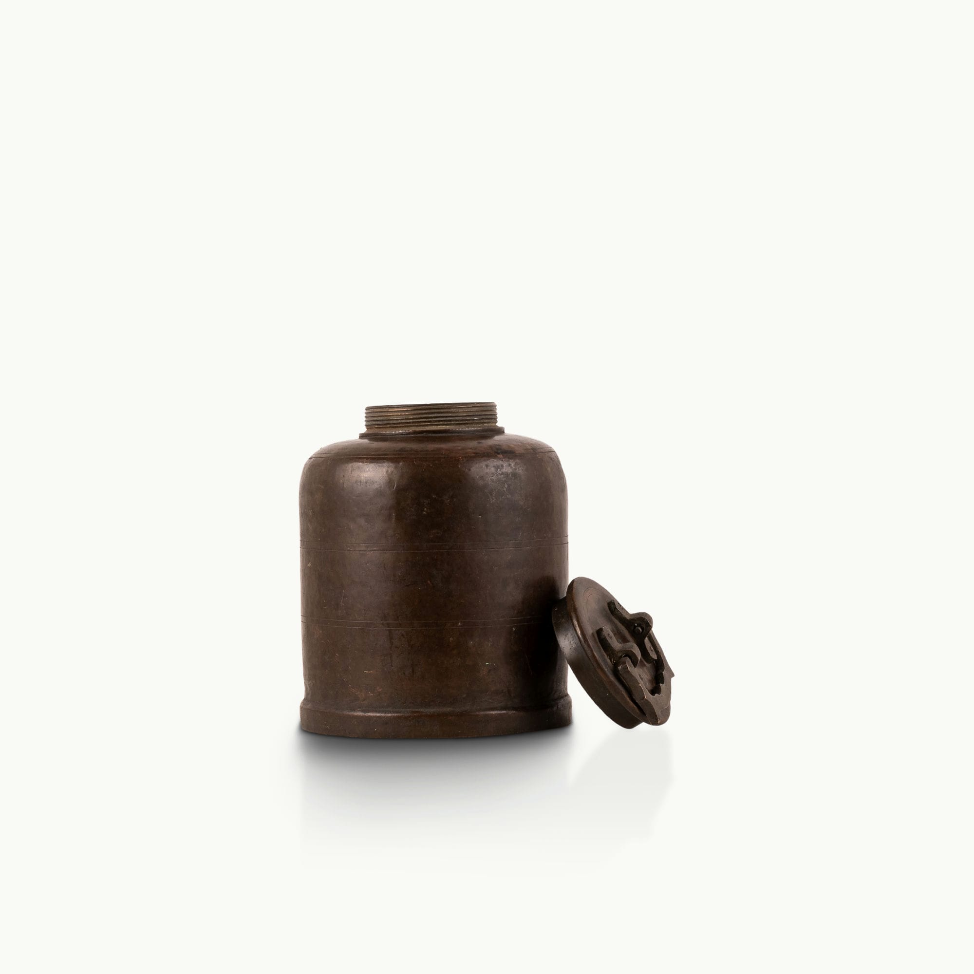 Antique Brass Canister secured by mechanical latches for a wood sideboard.