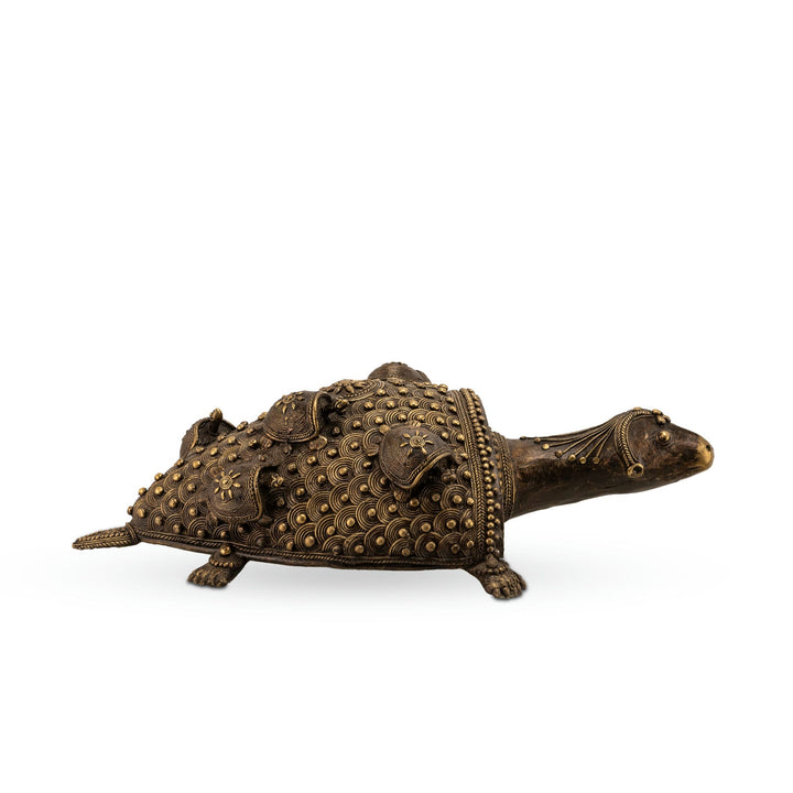 Antiqued Brass Turtle Sculpture featuring coiled motifs on a wide coffee table